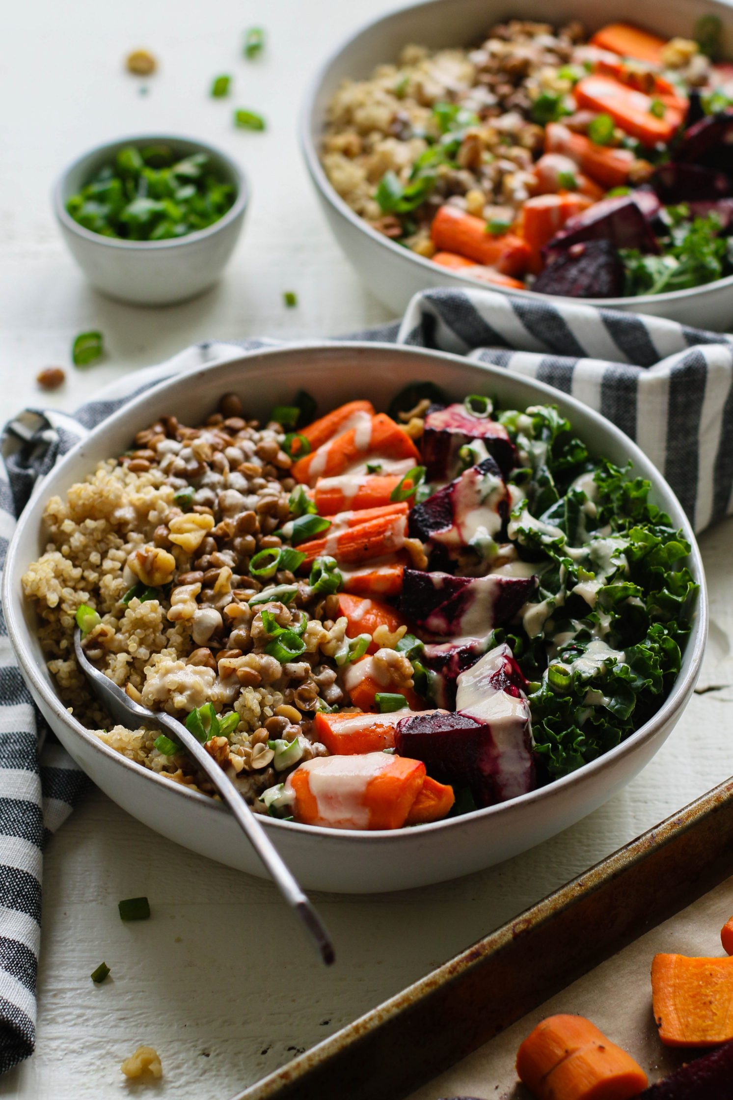 Roasted Beet Macro Bowl served in bowls with lemon tahini dressing with fork by Flora & Vino