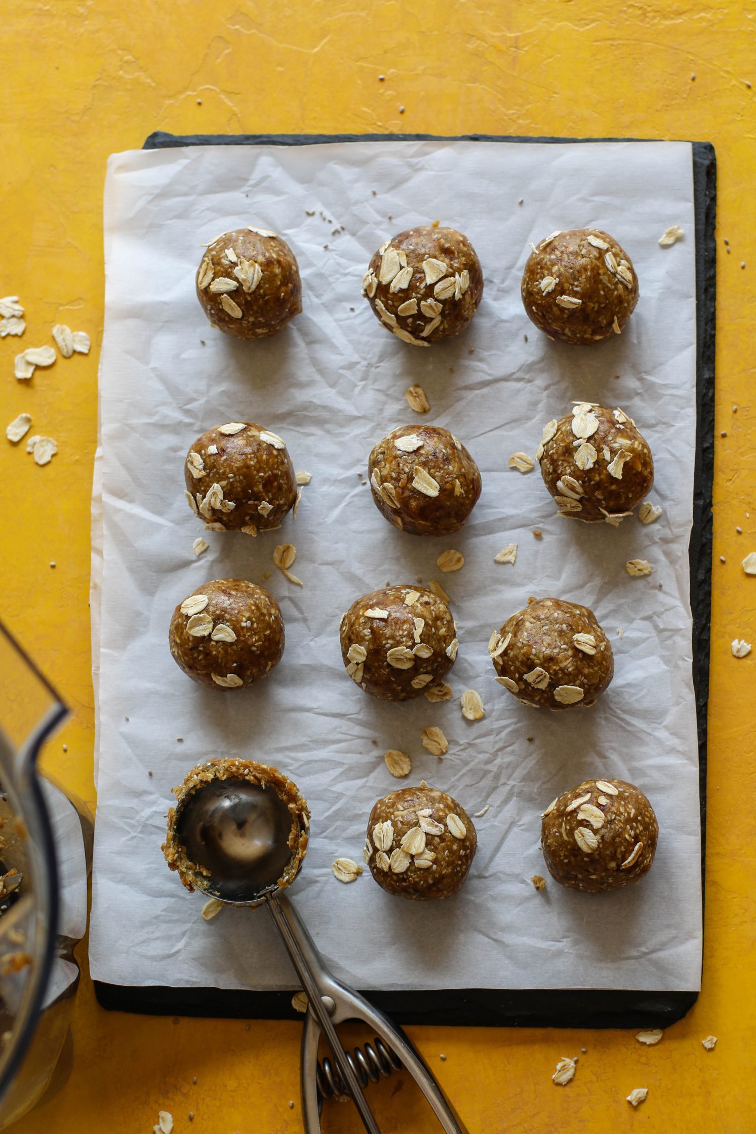  SunButter Date Bliss Balls rolled onto parchment lined by board by Flora & Vino 