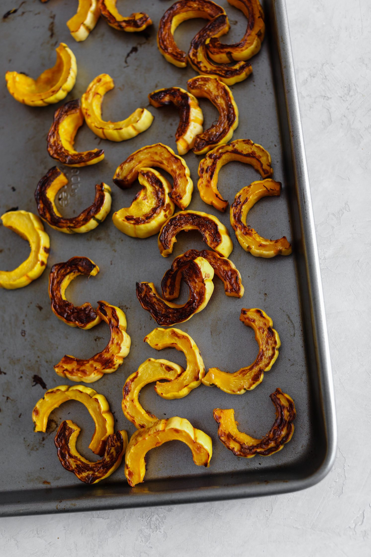 roasted delicata squash on baking sheet by Flora & Vino