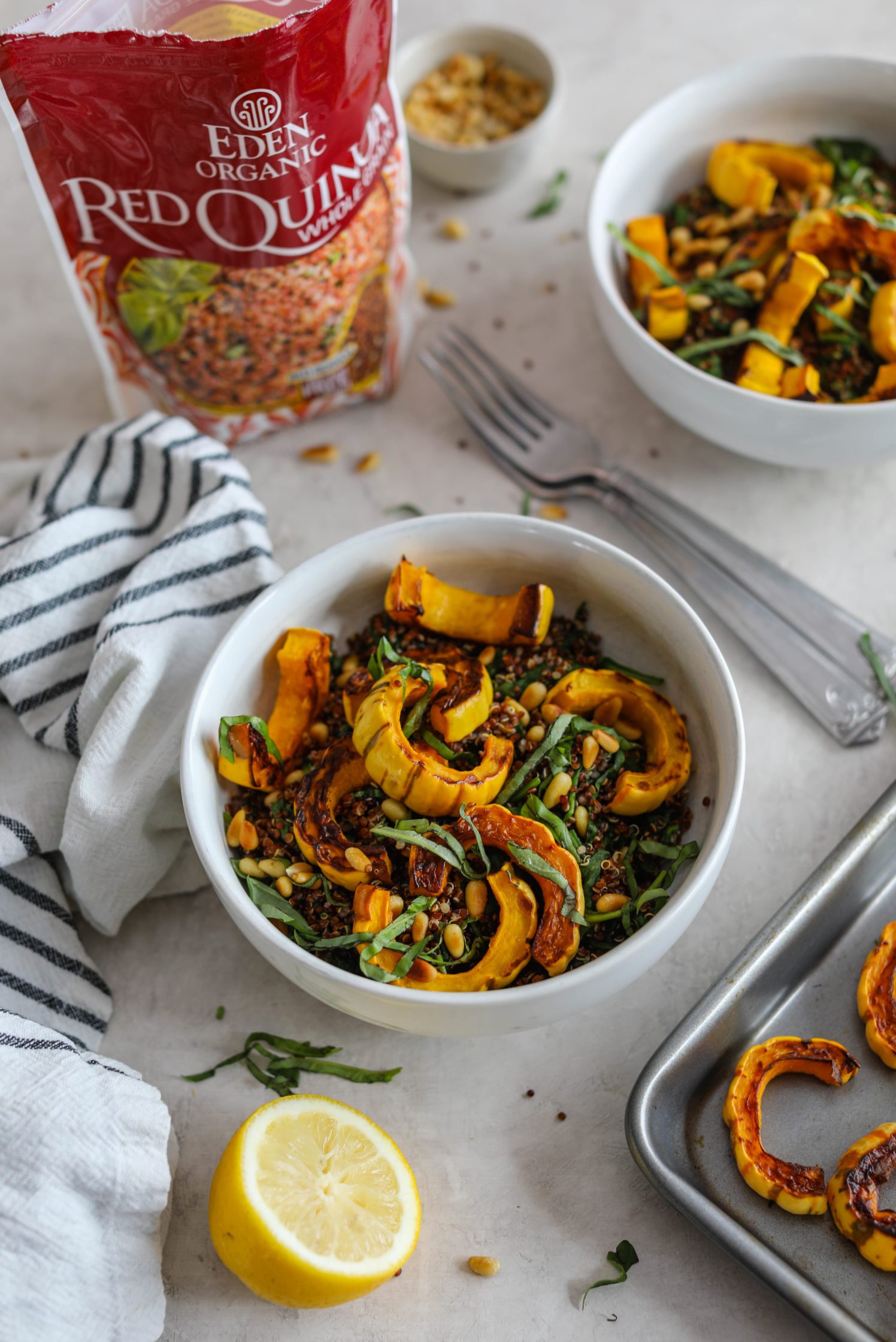 Delicata Squash Quinoa Power Bowls served with forks and lemon by Flora & Vino 