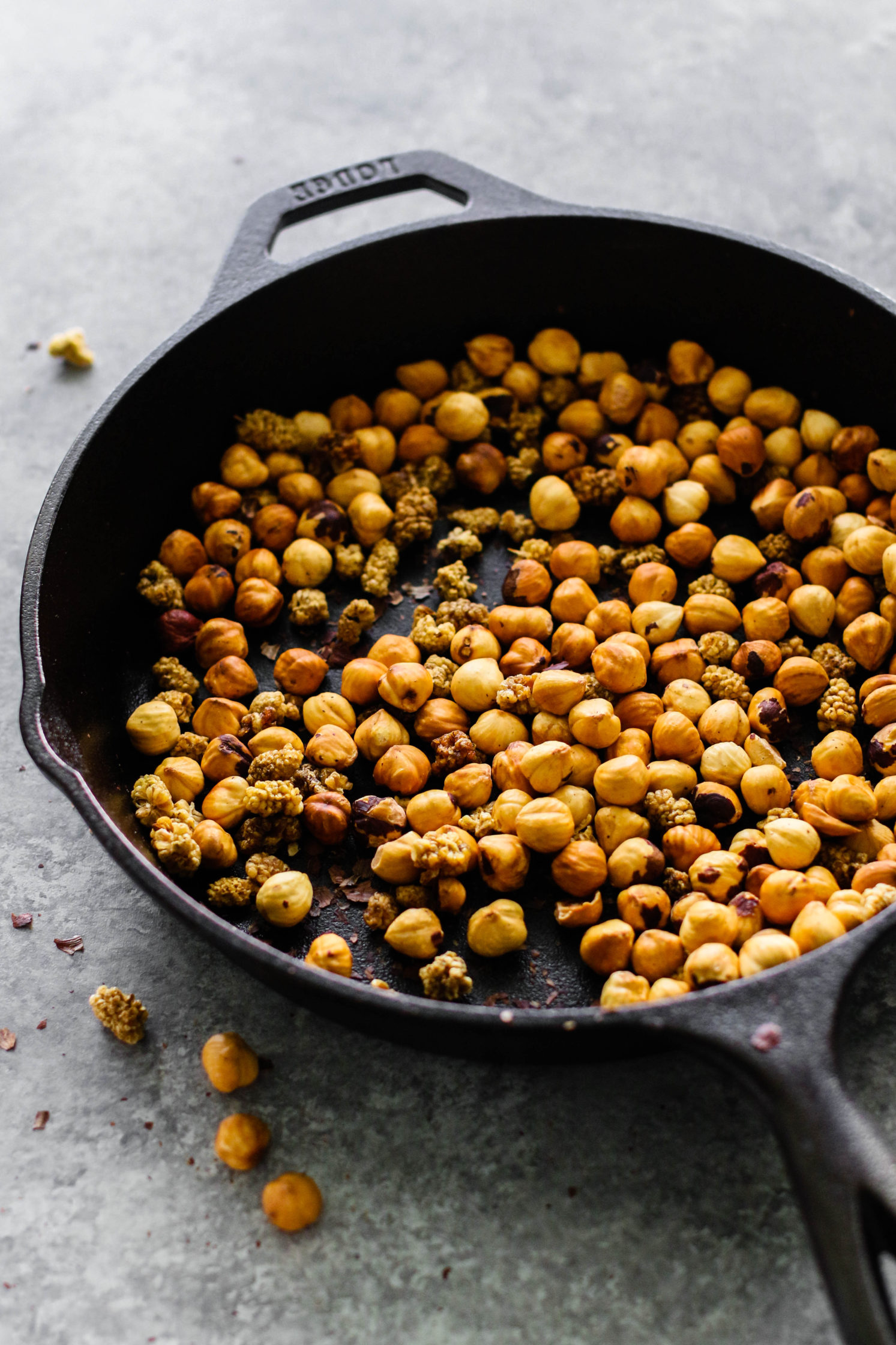 hazelnuts and mulberries toasted in cast iron skillet by Flora & Vino