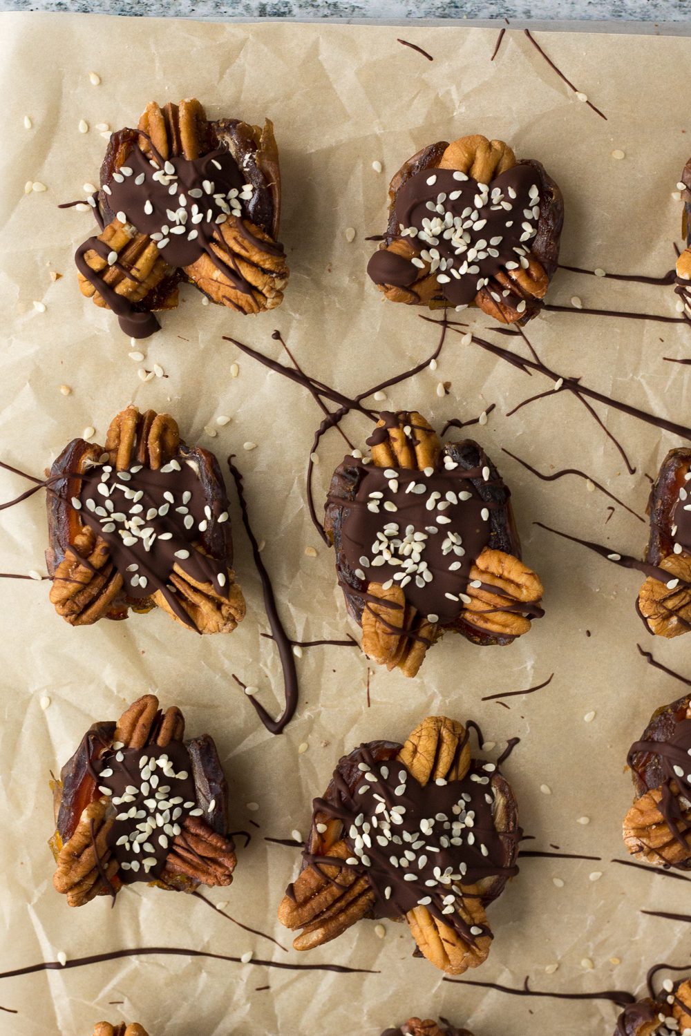 4-Ingredient Tahini Date Turtles on parchment paper by Flora & Vino