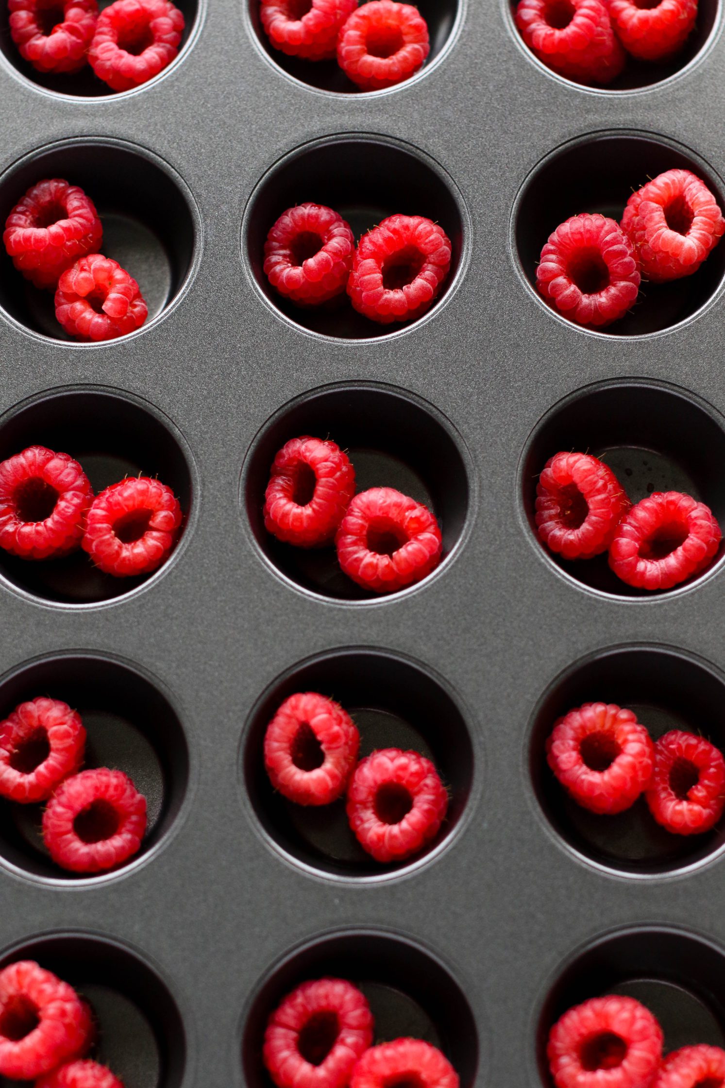 raspberries standing in muffin tin 