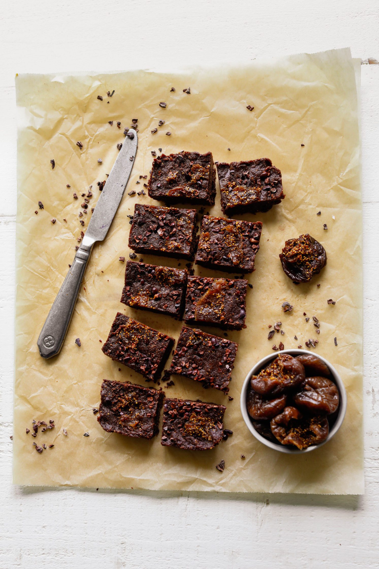 Chocolate Fig Freezer Fudge sliced on parchment paper by Flora & Vino 