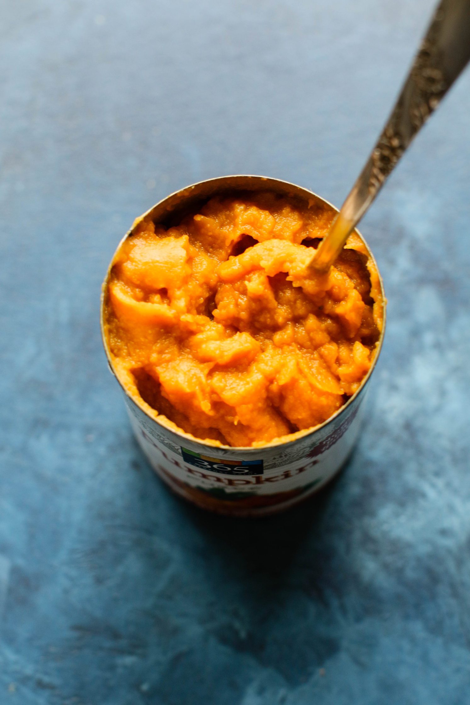 Pumpkin puree in can with spoon