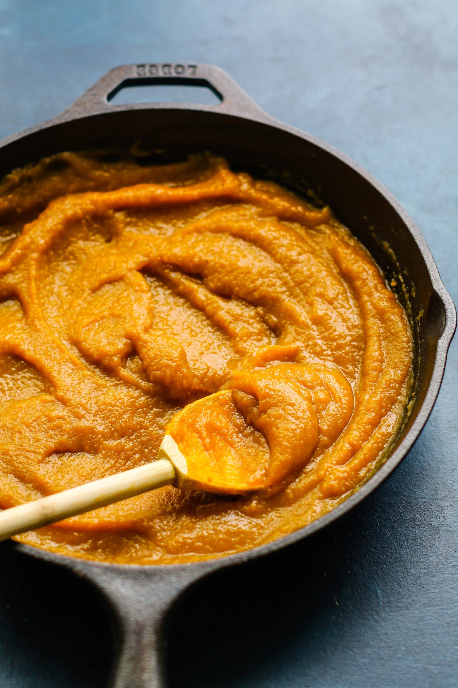Low Sugar Pumpkin Apple Butter served in pan with wooden spoon