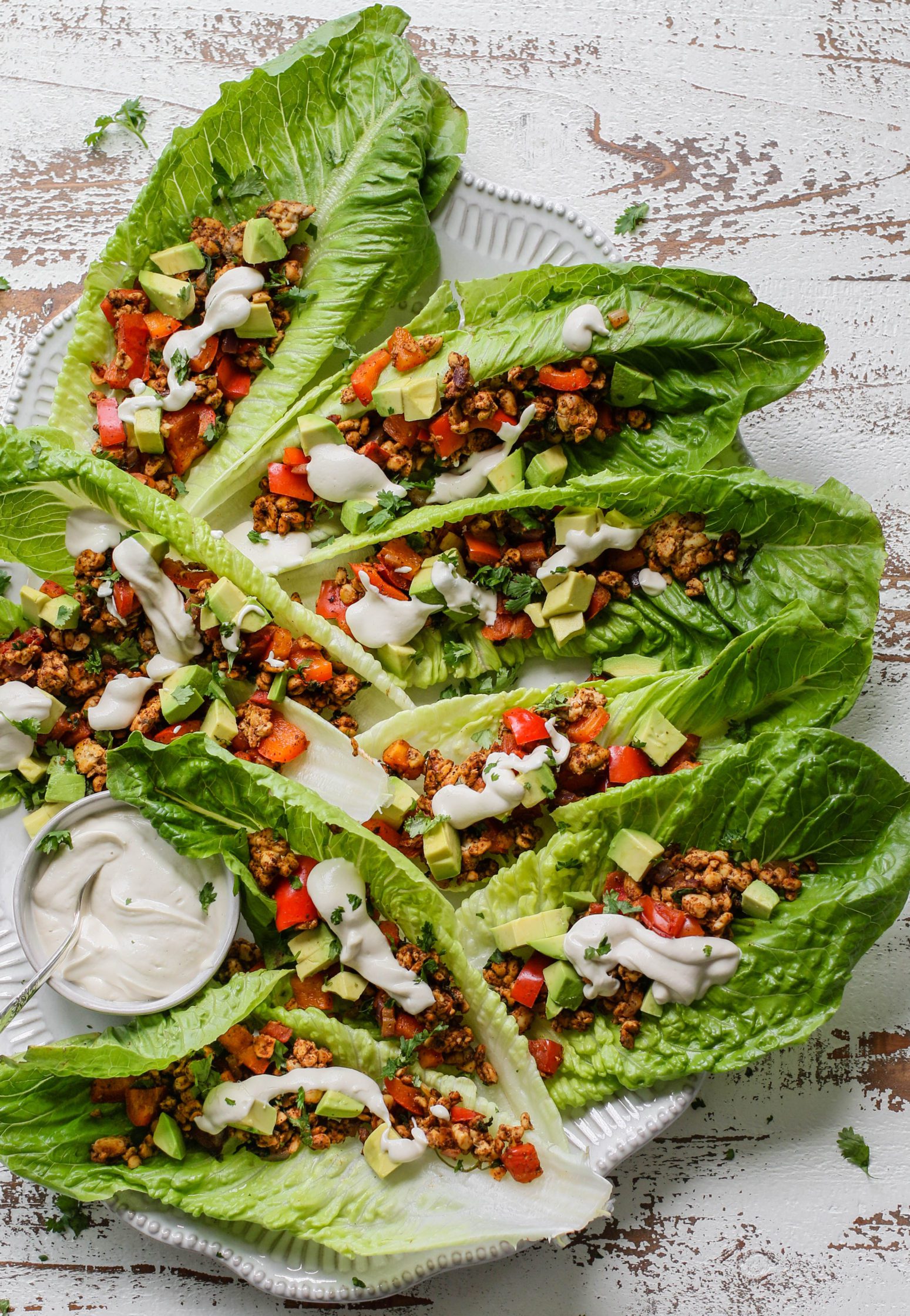 Romaine Tempeh Tacos served on a platter with cashew sour cream 