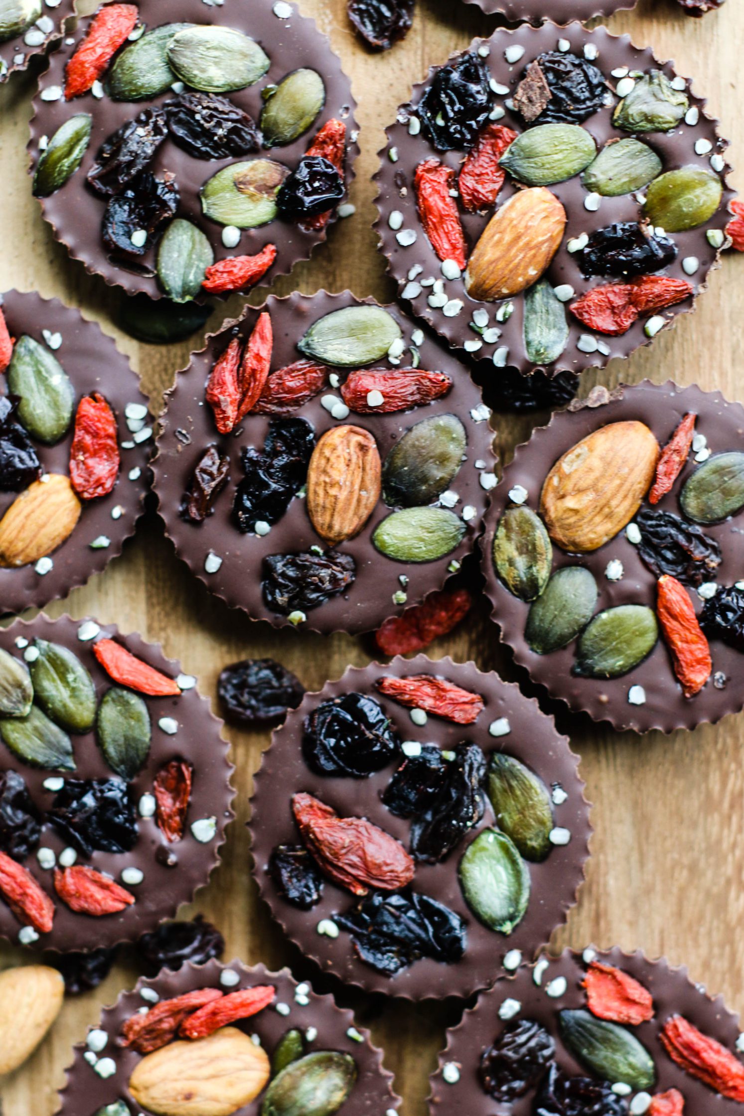 Superfood Chocolate Maca Cups served on wooden board with superfoods