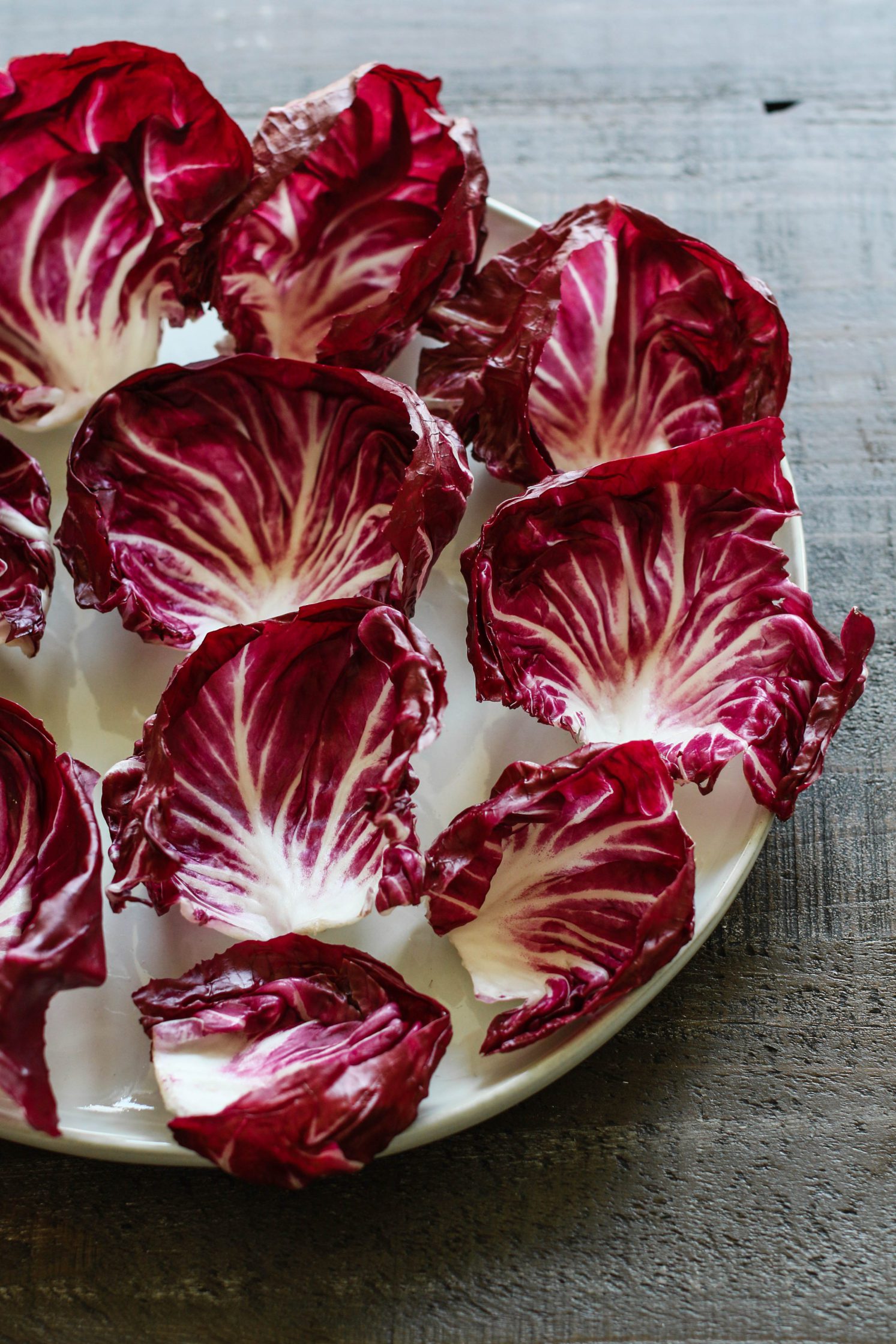 Radicchio leaves on a plate by Flora & Vino
