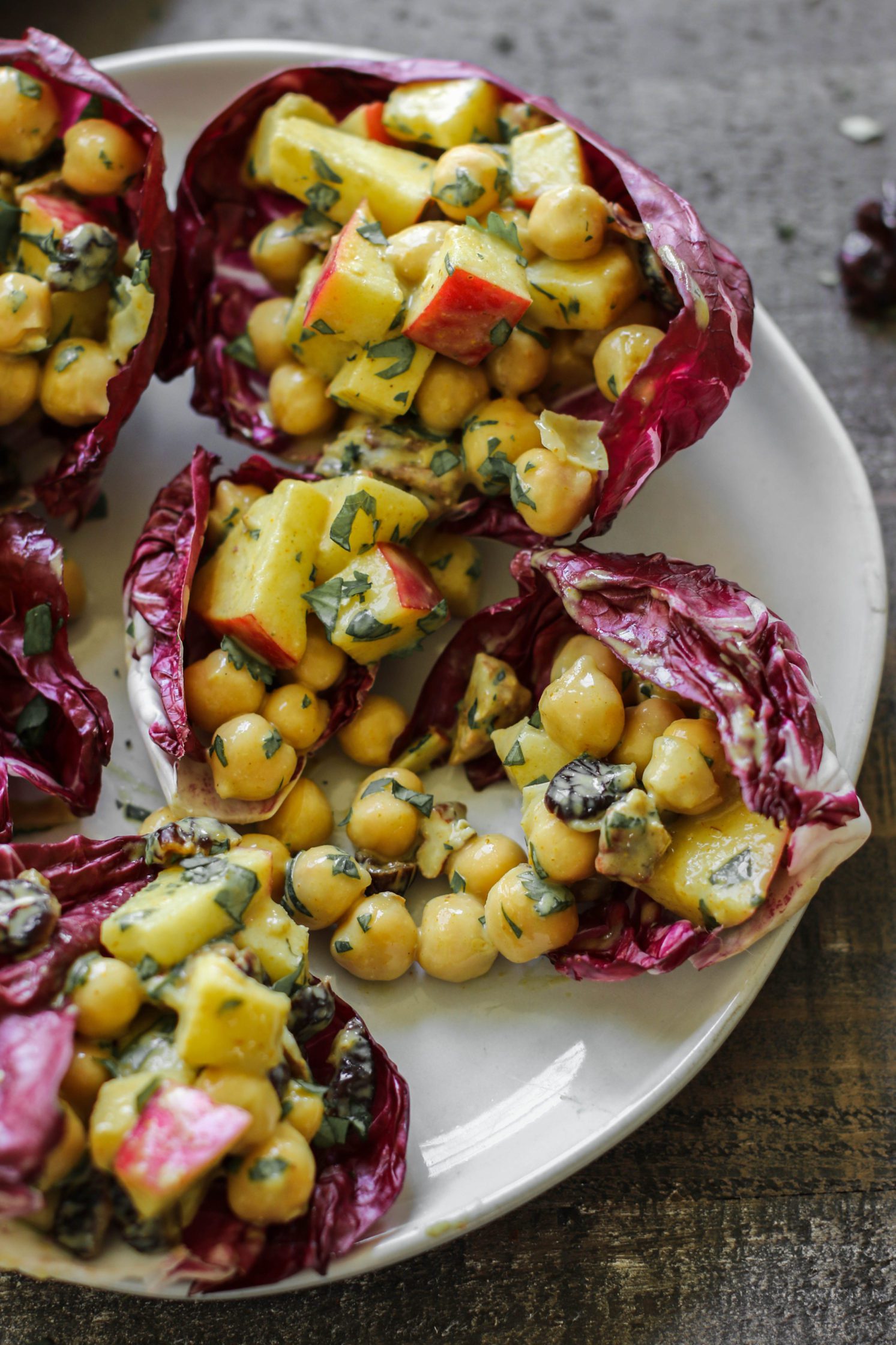 Curried Cranberry Apple Chickpea Salad Cups served on a plate by Flora & Vino