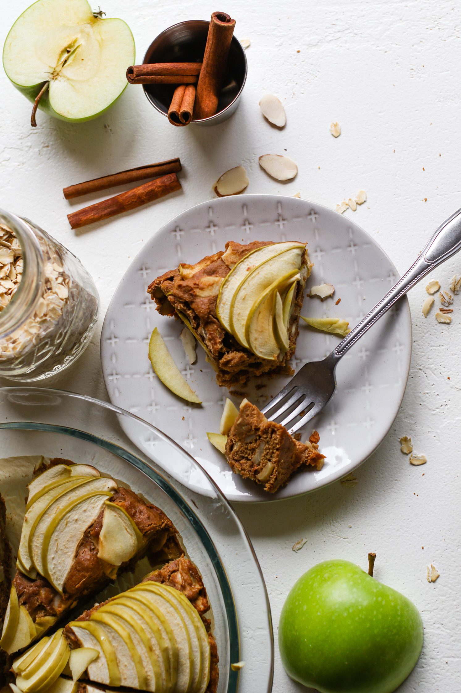 1-Bowl Apple Oat Cake plated with one fork bite by Flora & Vino