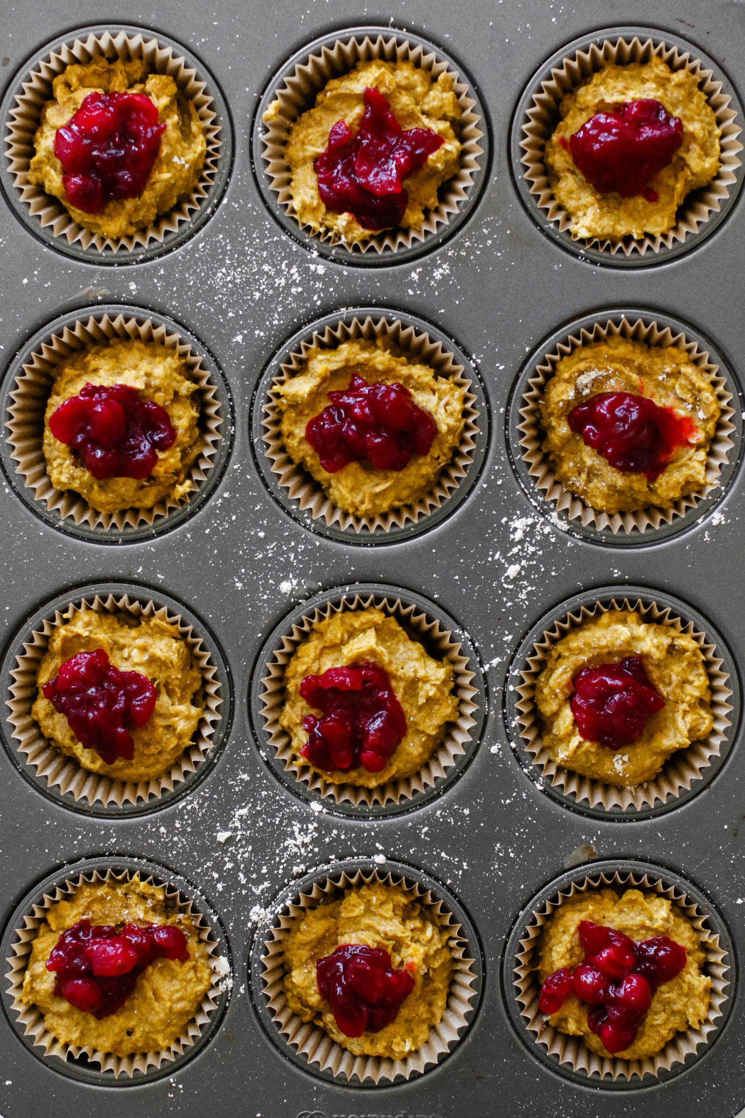 Kabocha Squash Cranberry Muffins in muffin tin 