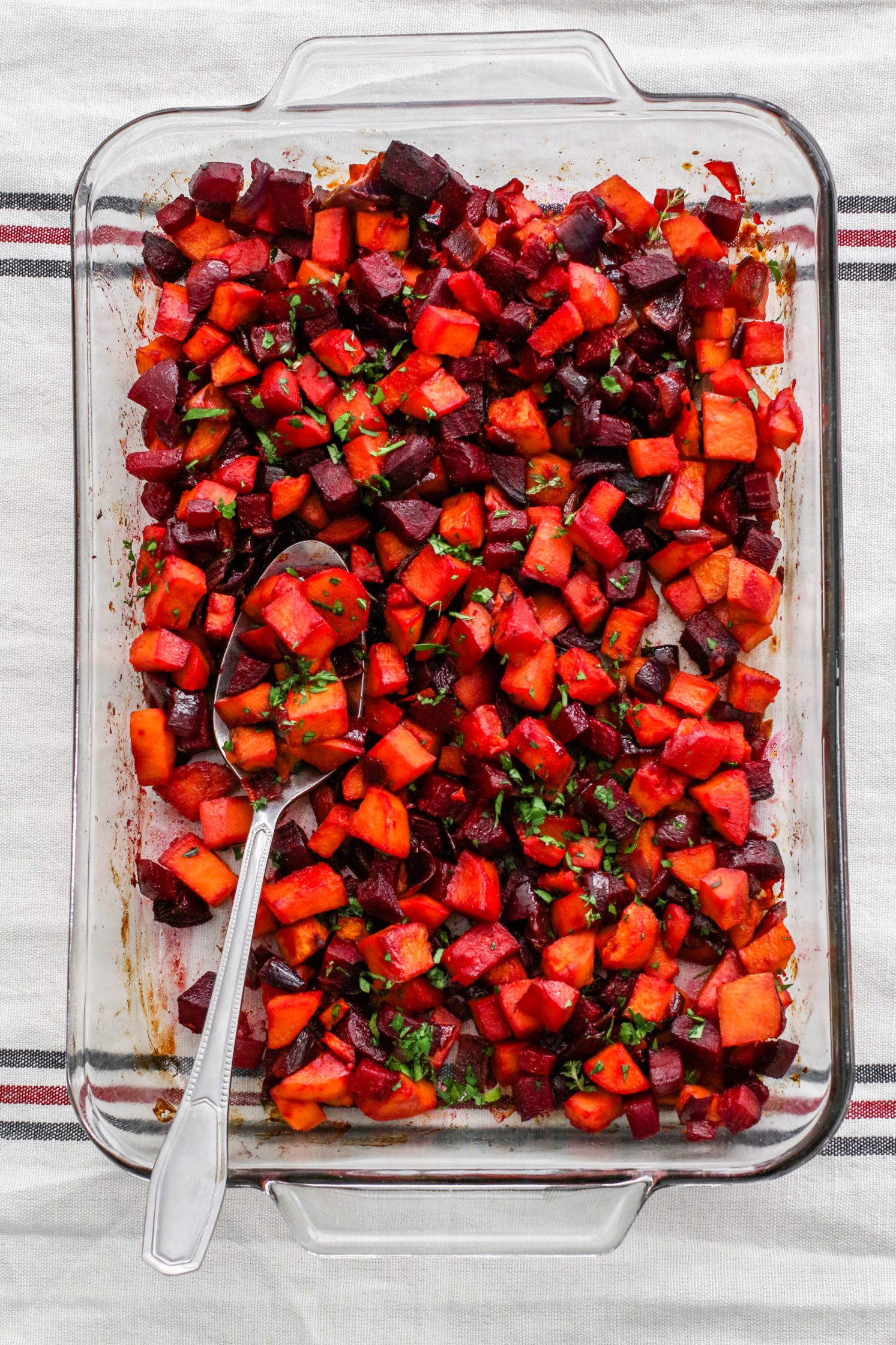 Sweet Potato & Beet Breakfast Hash in glass dish with spoon 