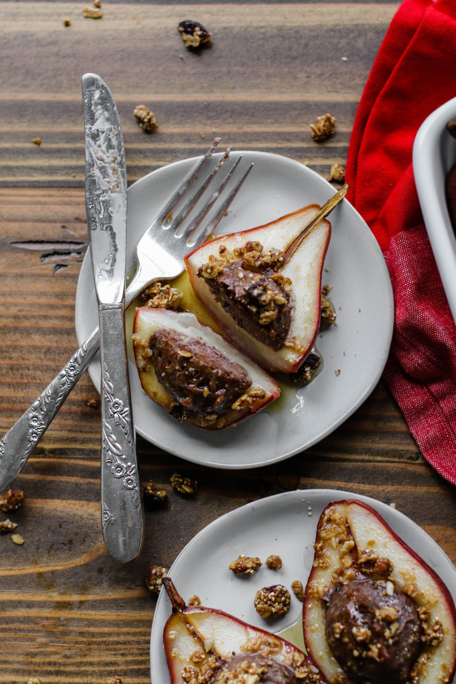 Nutty Protein Stuffed Pears served on plate and cut in half by Flora & Vino