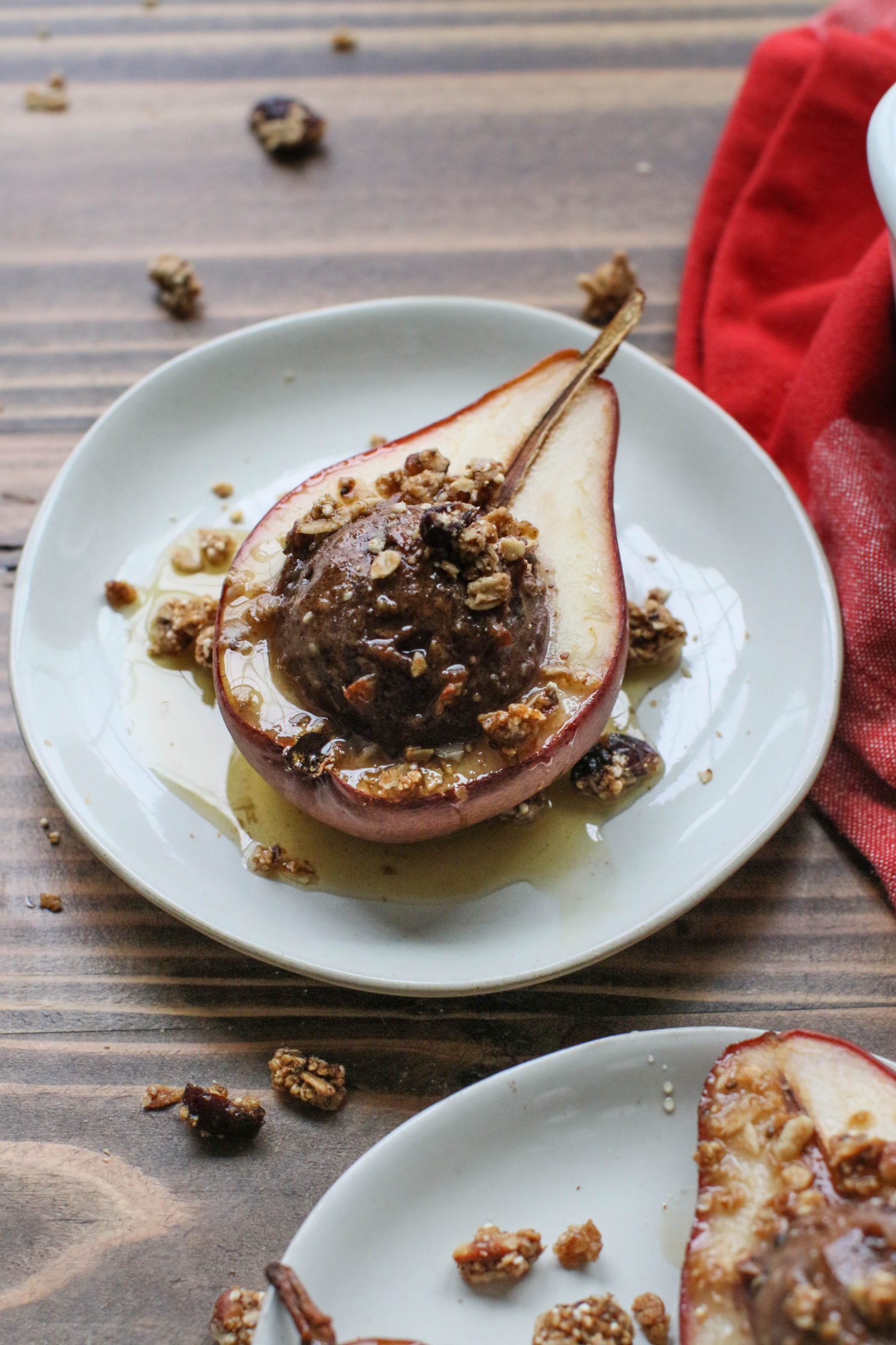 Nutty Protein Stuffed Pears served on a plate by Flora & Vino