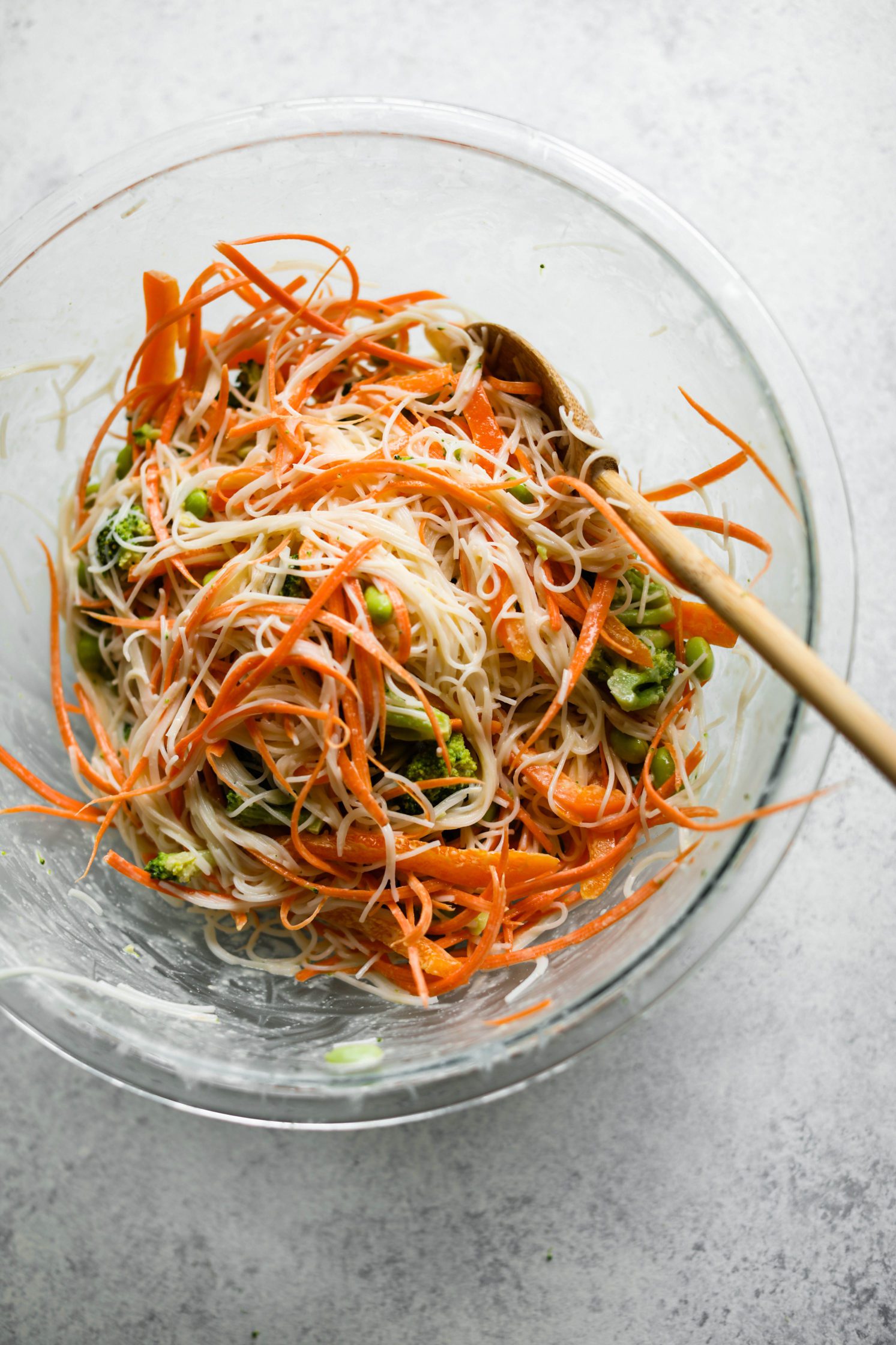 Rainbow Rice Noodle Bowls with Miso Tahini Dressing mixed in bowl