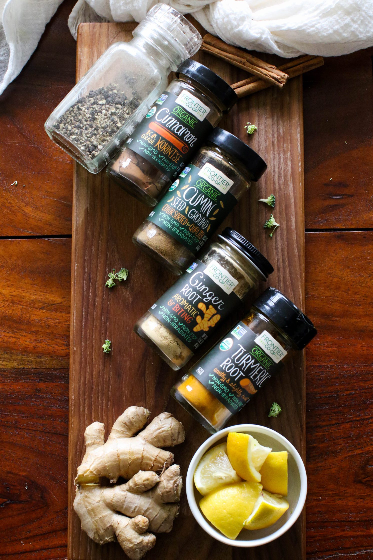 spices and seasonings with ginger and lemon on a wooden board by Flora & Vino
