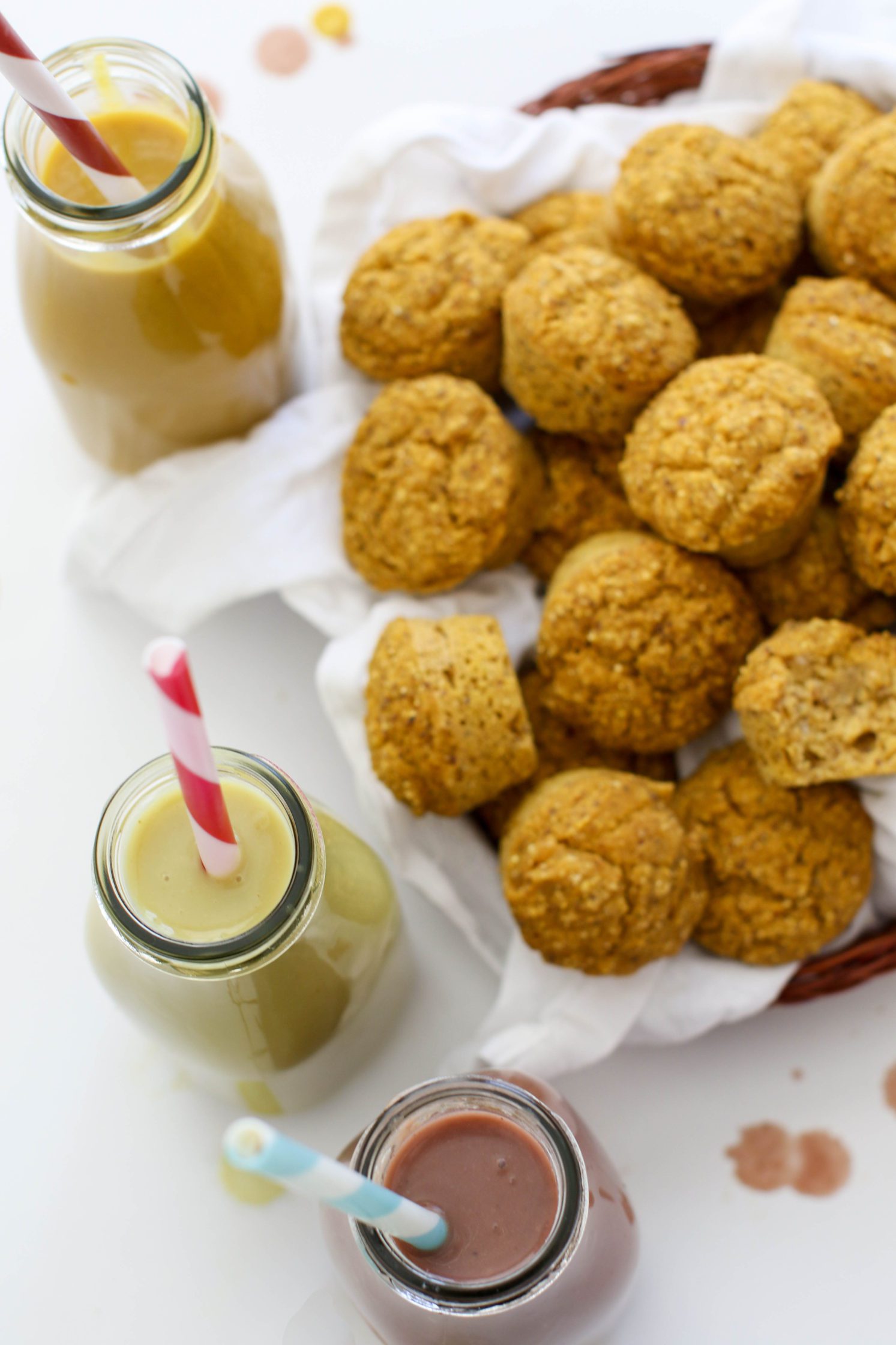 Pumpkin Cornbread Mini Muffins served in woven basket with white towel with soups in jar with straw
