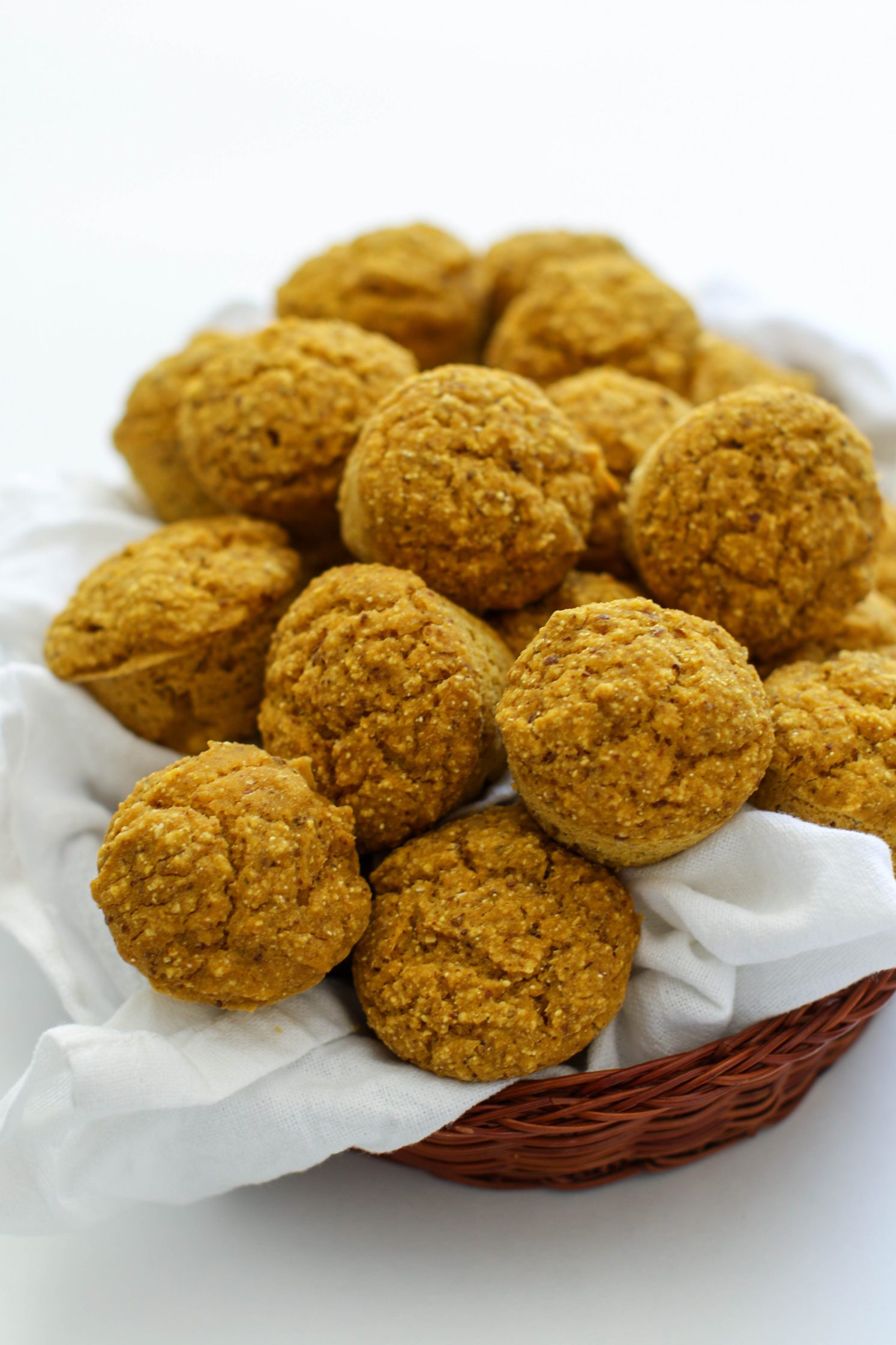 Pumpkin Cornbread Mini Muffins served in woven basket with white towel