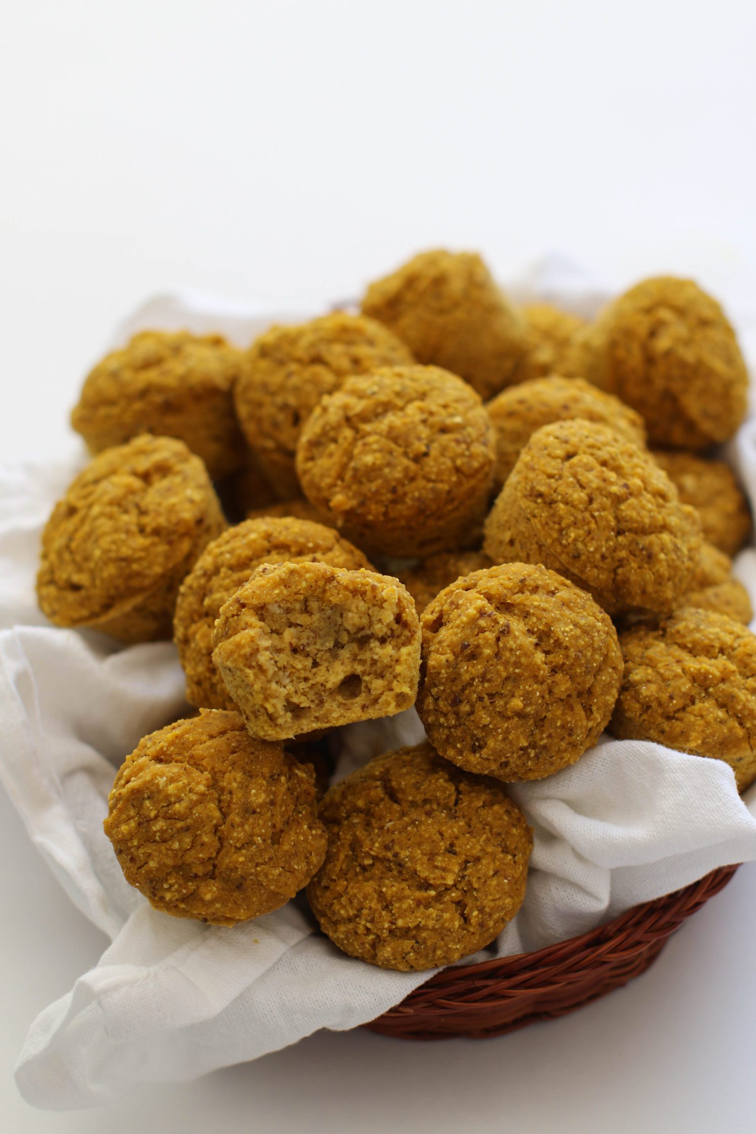 Pumpkin Cornbread Mini Muffins served in woven basket with white towel