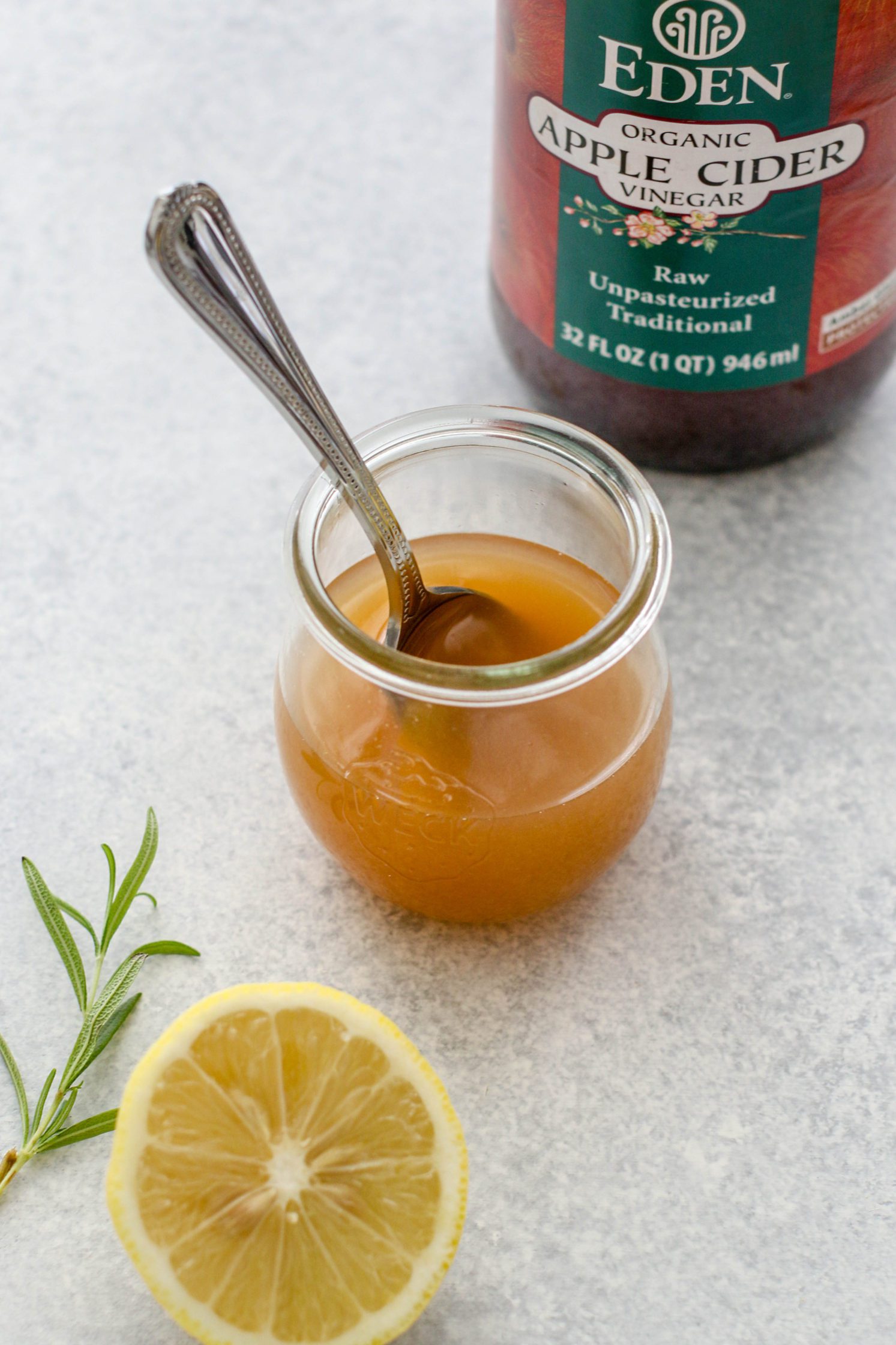 apple cider vinegar mixed in mason jar with spoon 