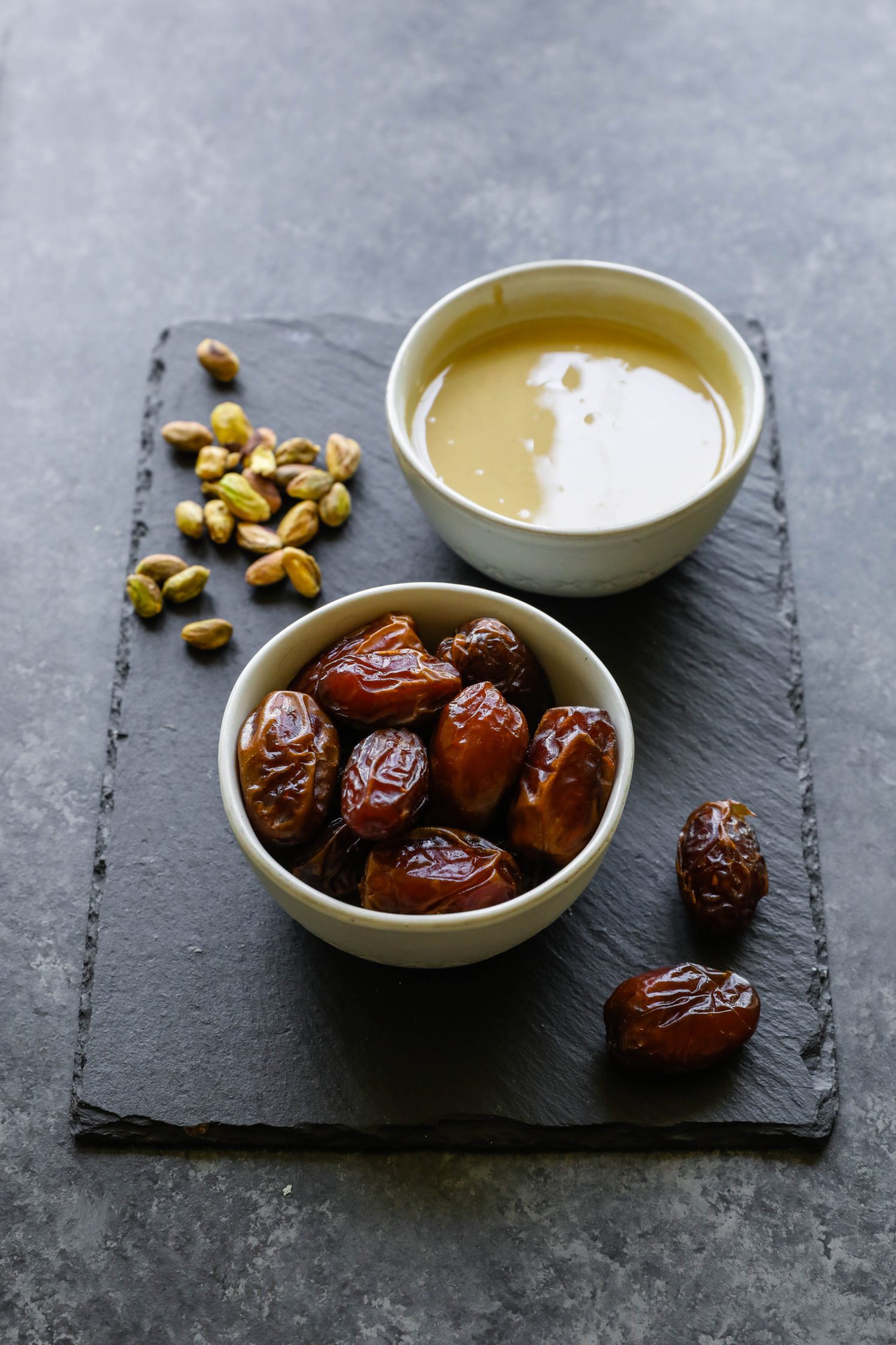 dates, pistachios, and tahini on a serving board by Flora & Vino