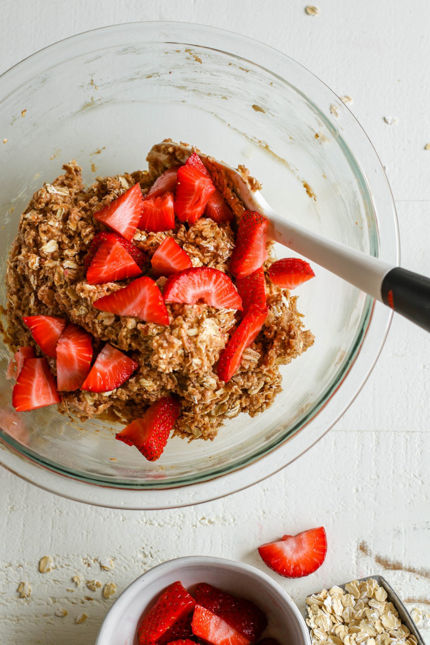 PB&J Baked Breakfast Bar batter with chopped strawberries mixed in and spatula by Flora & Vino