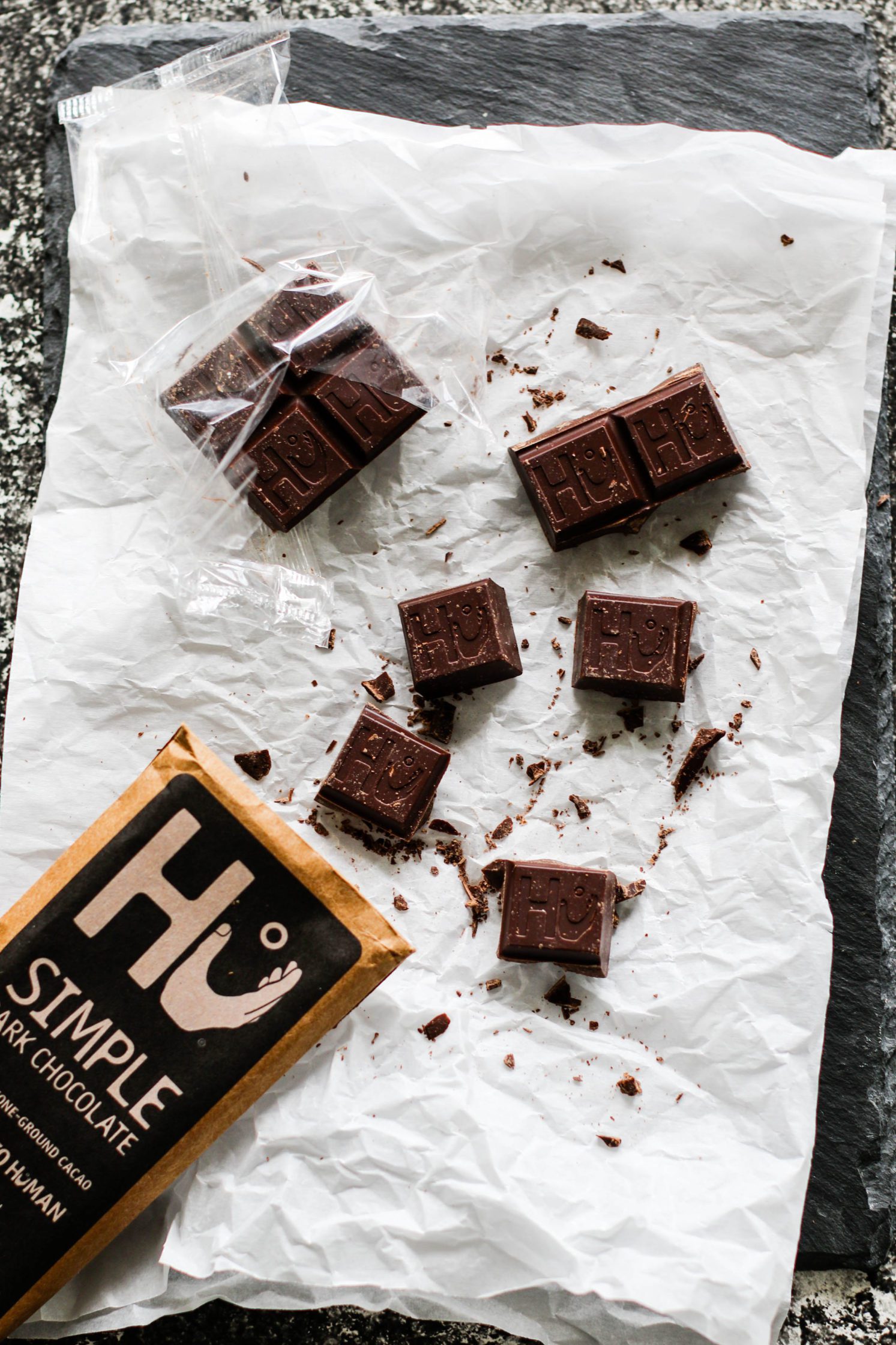 Hu Chocolate on parchment paper broken into pieces by Flora & Vino