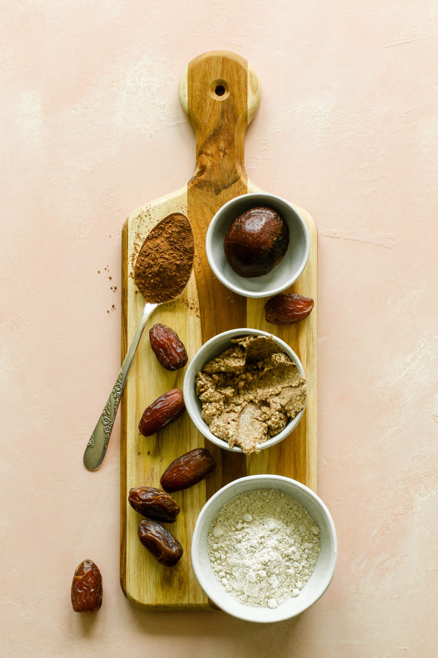Beet Brownie Bliss Ball ingredients served on wooden board by Flora & Vino