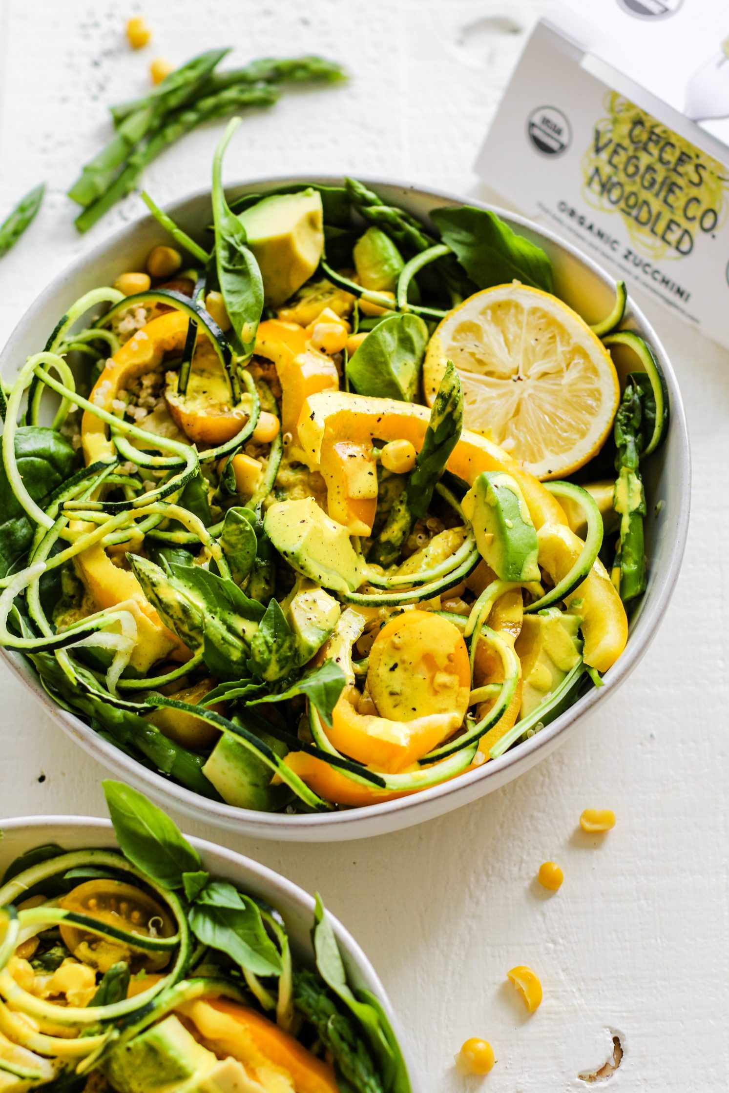 Summer Spinach Salad served in bowls with Turmeric Tahini Dressing