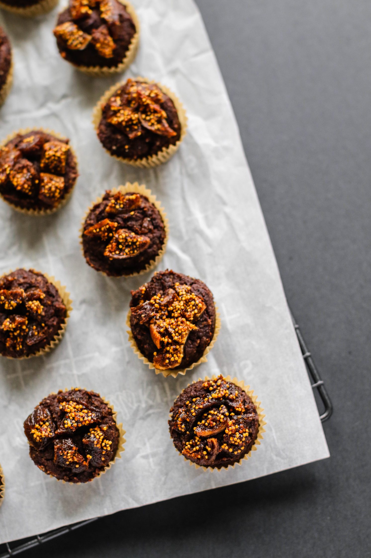 Chocolate Fig Hazelnut Mini Muffins on parchment lined cooling rack