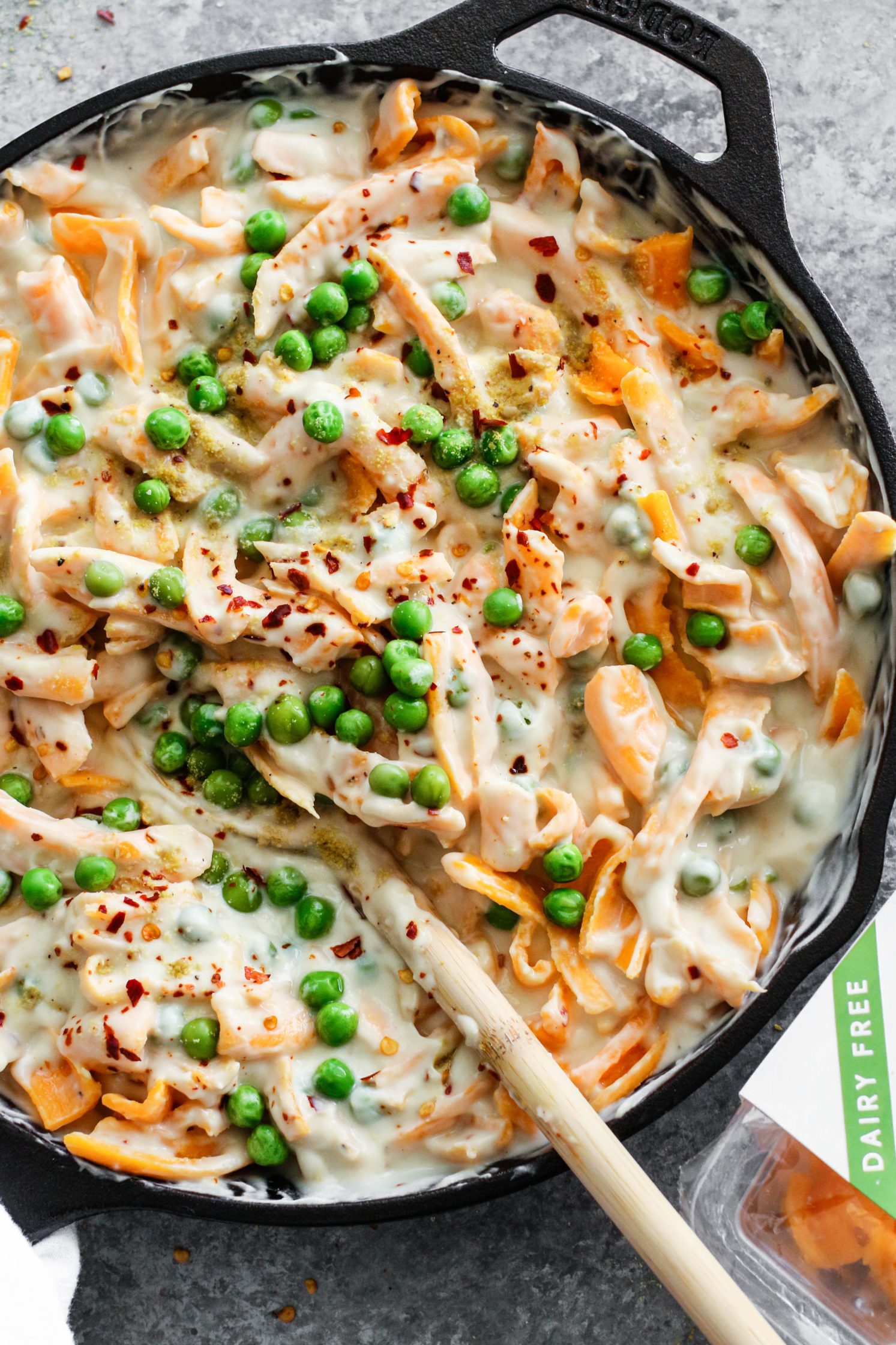 Cauliflower Cashew Butter Alfredo in skillet with wooden spoon 