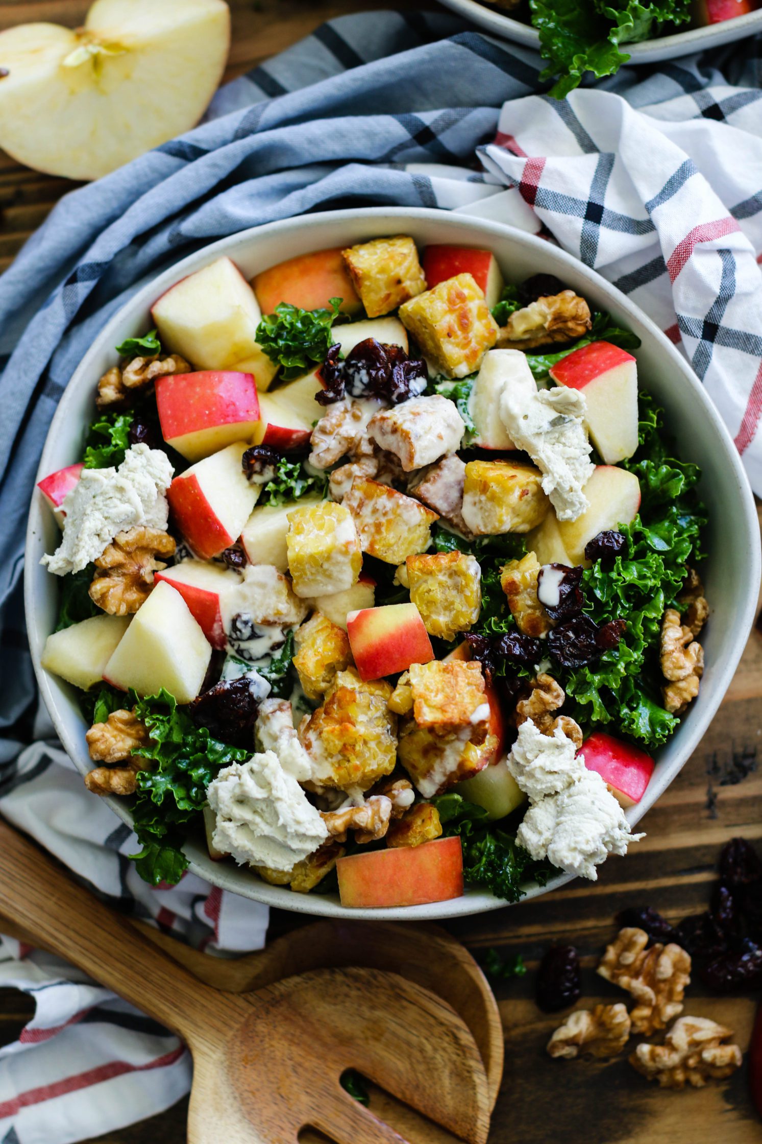 Cran-Apple Tempeh Kale Salad served in bowls with tahini dressing by Flora & Vino