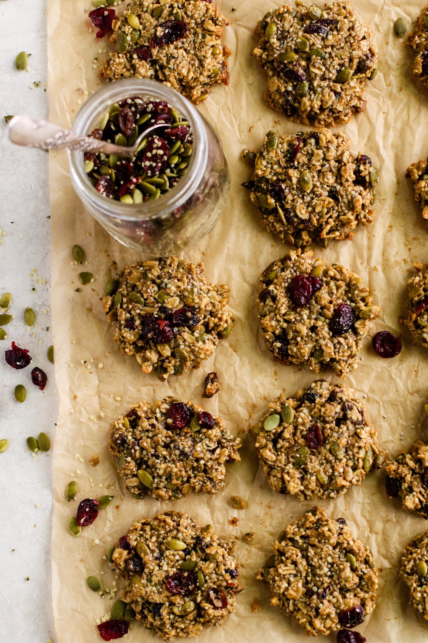 Healthy Trail Mix Cookies on parchment paper by Flora & Vino