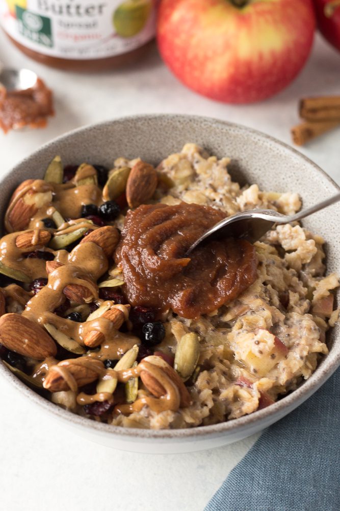 Apple Butter Stovetop Oats with apple butter on top and spoon by Flora & Vino