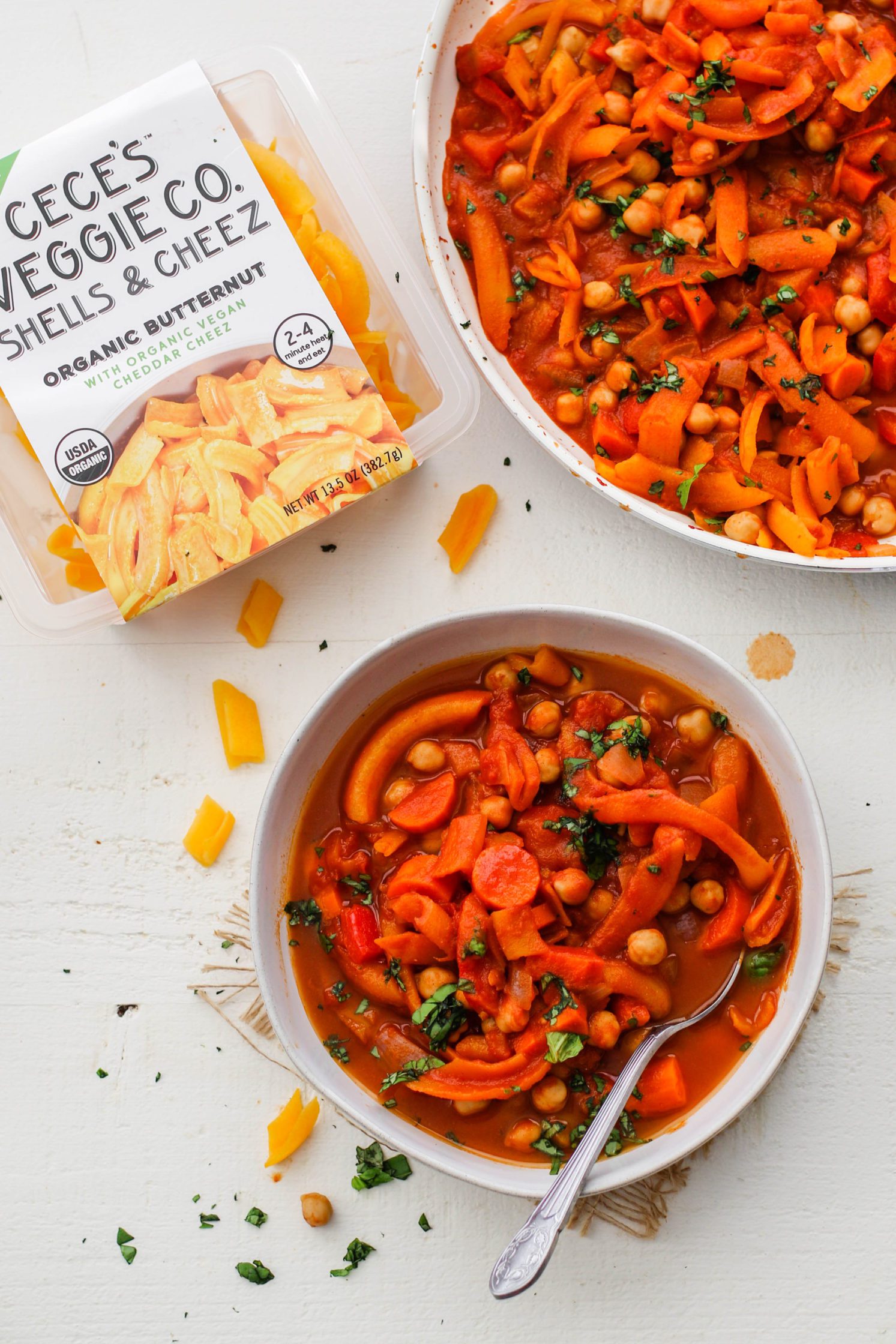 5-Spice Squash & Chickpea Stew served in bowl topped with herbs with spoon