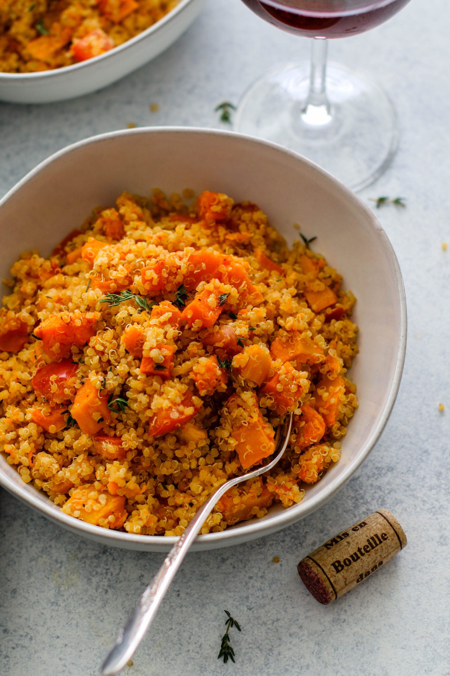 Roasted Butternut Squash Quinoa Risotto served in bowls with a fork by Flora & Vino