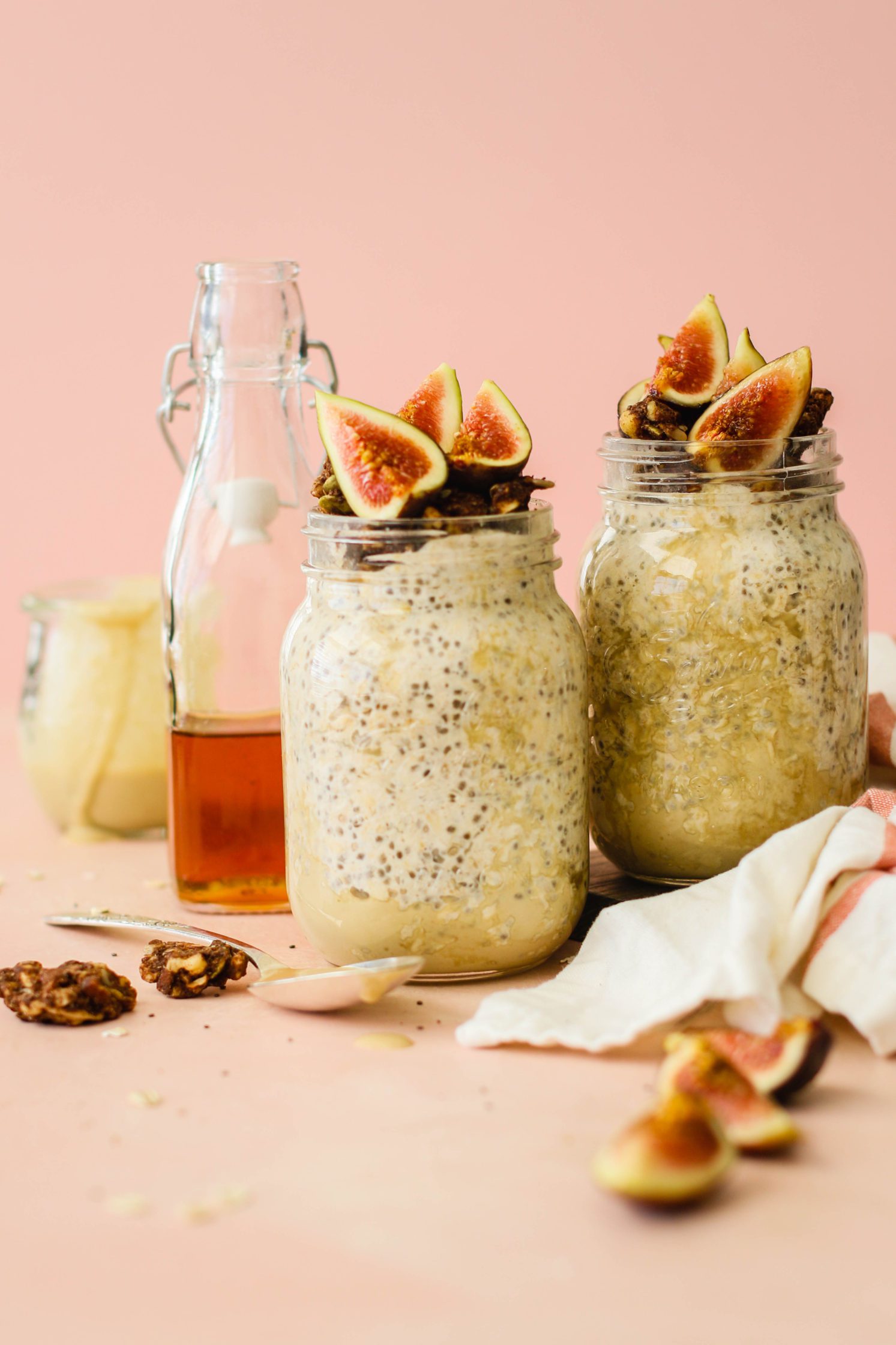 Maple Tahini Overnight Oats in mason jars topped with figs and maple syrup by Flora & Vino