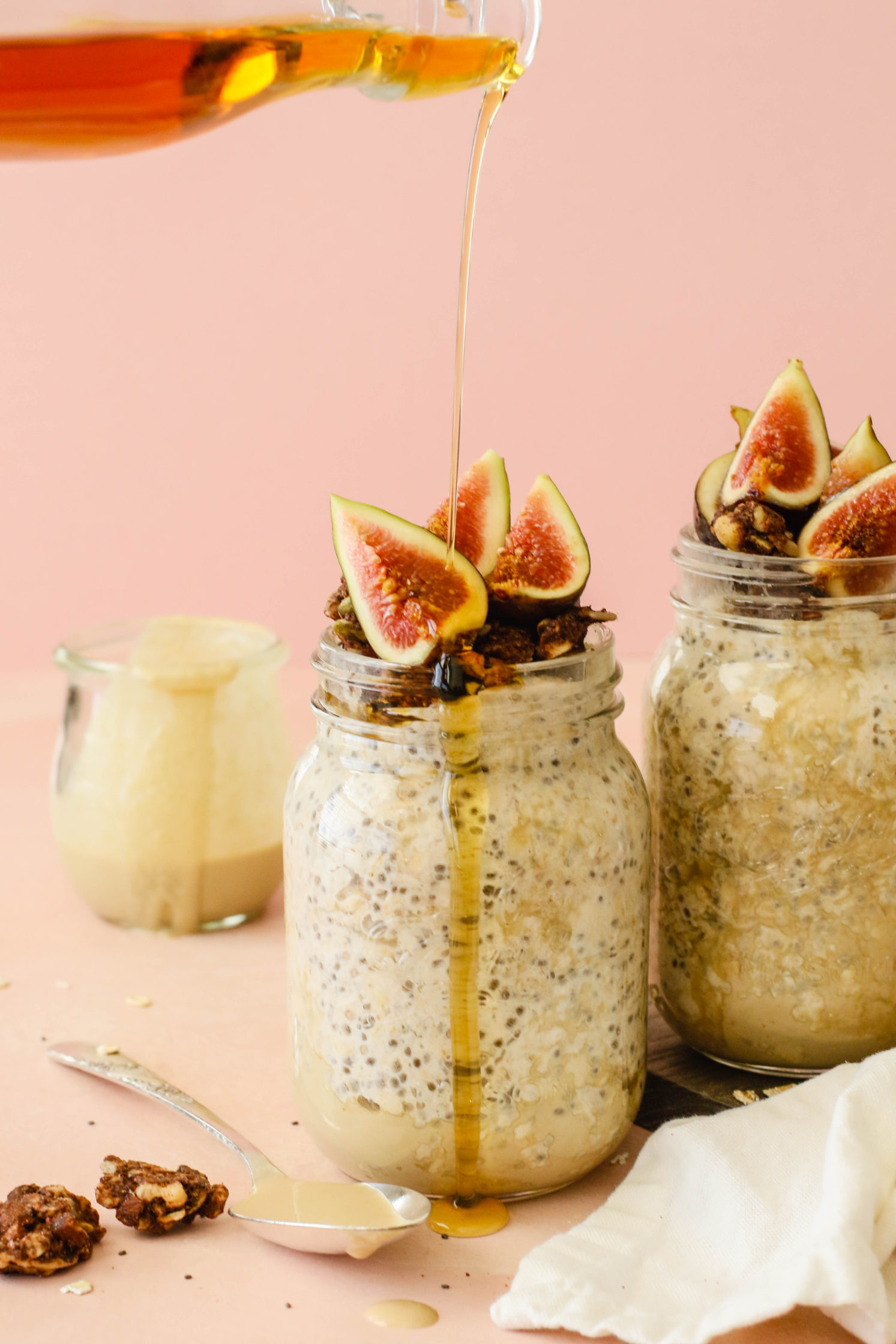 Maple Tahini Overnight Oats in mason jars with maple syrup drizzle by Flora & Vino
