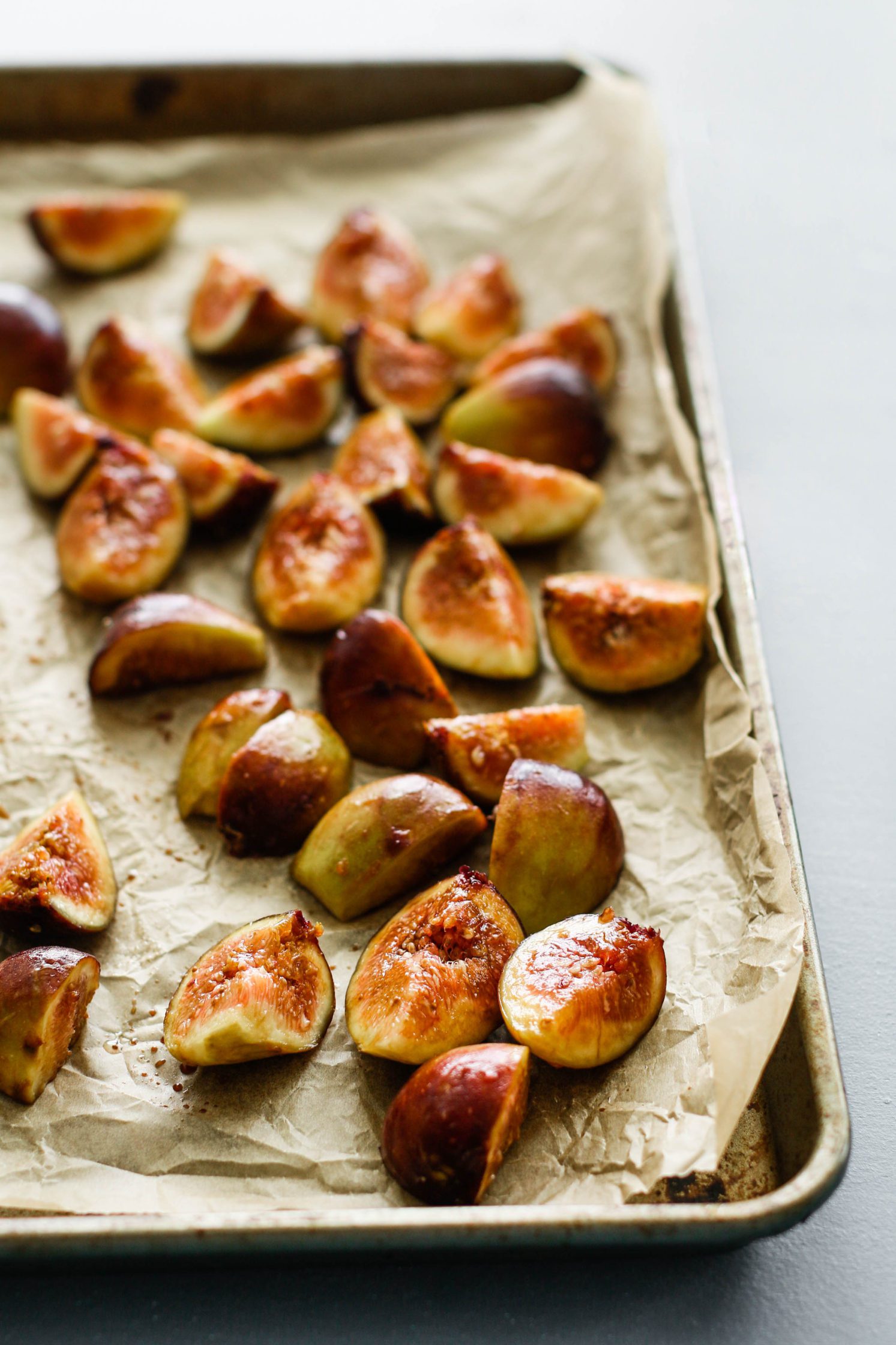 roasted figs on a parchment lined sheet pan by Flora & Vino