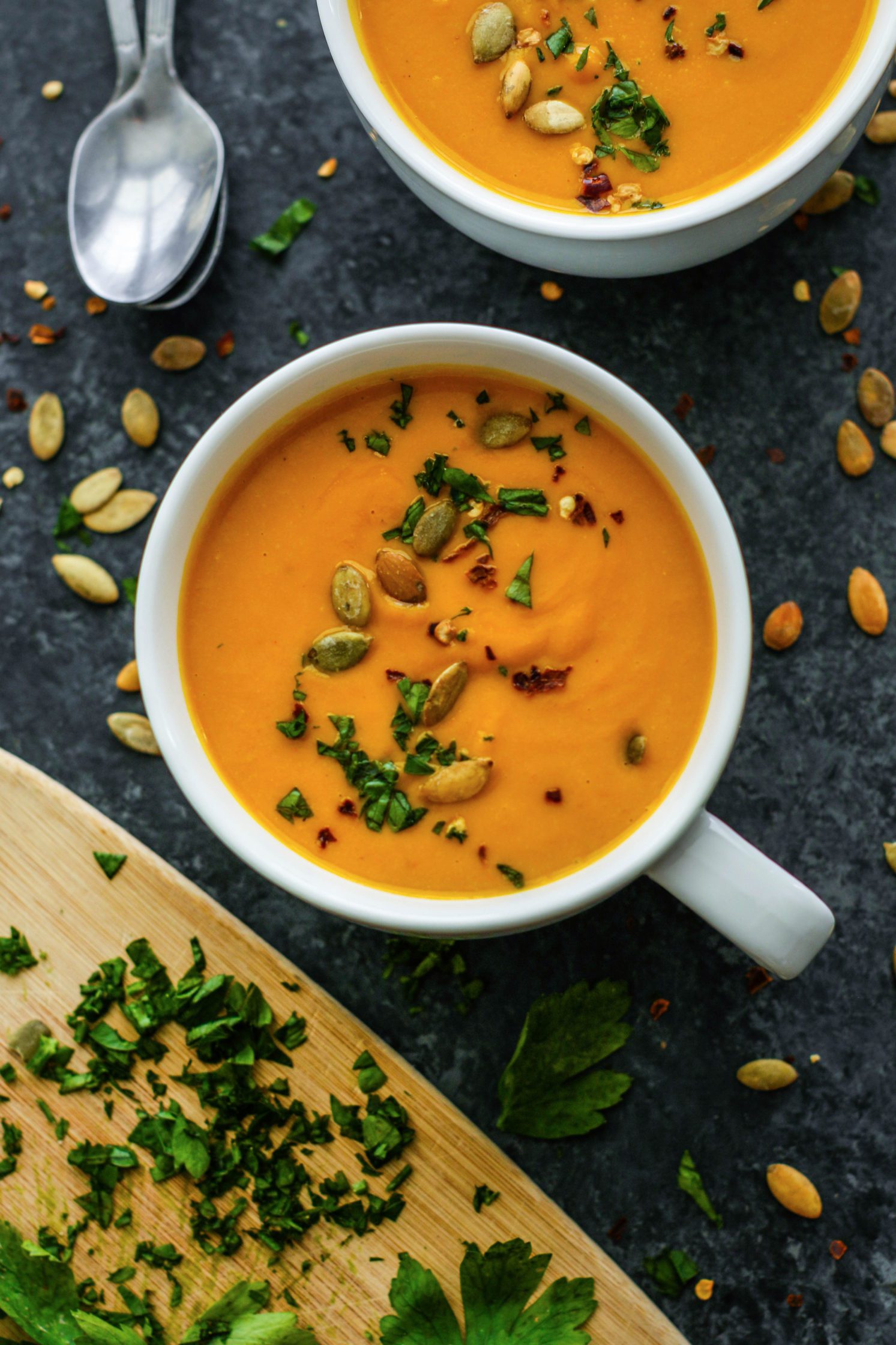 Roasted Pumpkin & Vegetable Soup served in mugs with fresh herbs and spoons