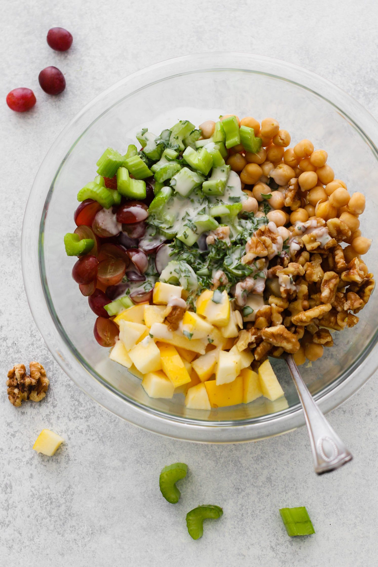 Chickpea Waldorf Salad ingredients in bowl with fork topped with parsley and fork 