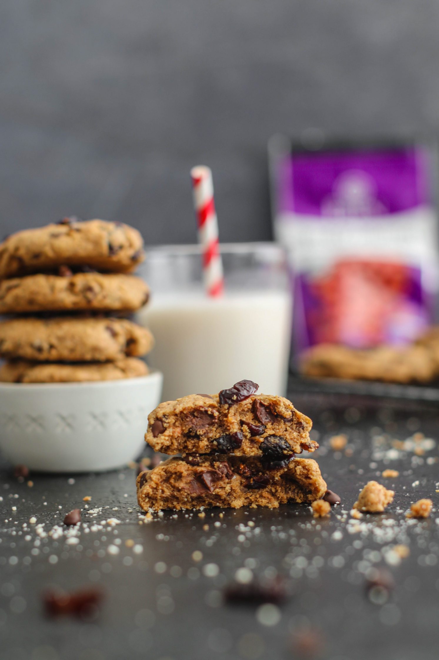 Cranberry Chocolate Chip Cookies stacked and broken in half by Flora & Vino