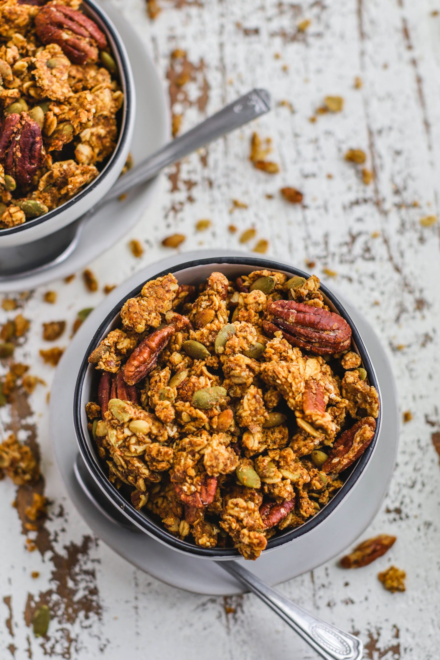 Pumpkin Spice Pecan Granola served in bowls with spoons by Flora & Vino