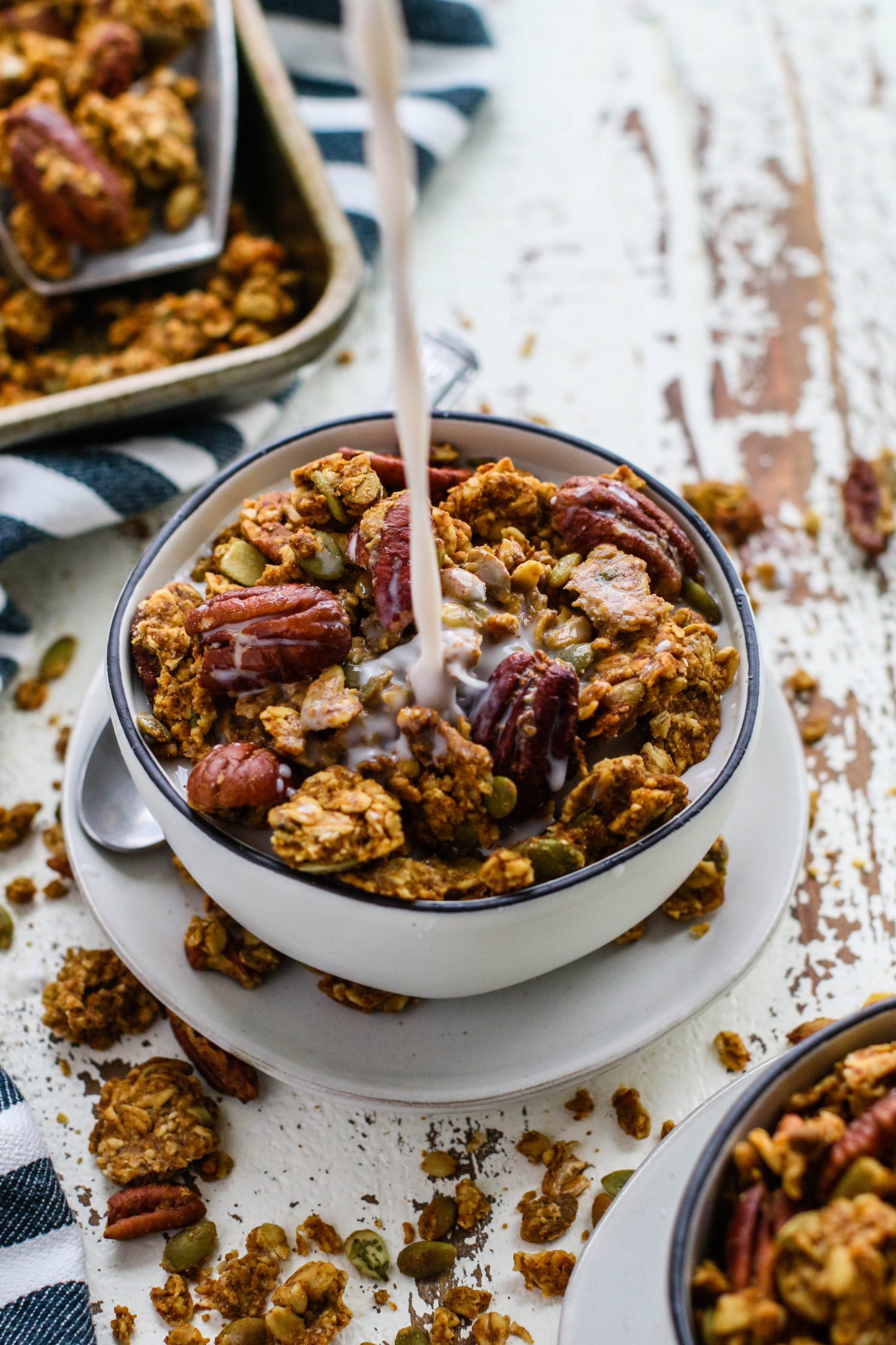 Pumpkin Spice Pecan Granola with milk poured on top by Flora & Vino