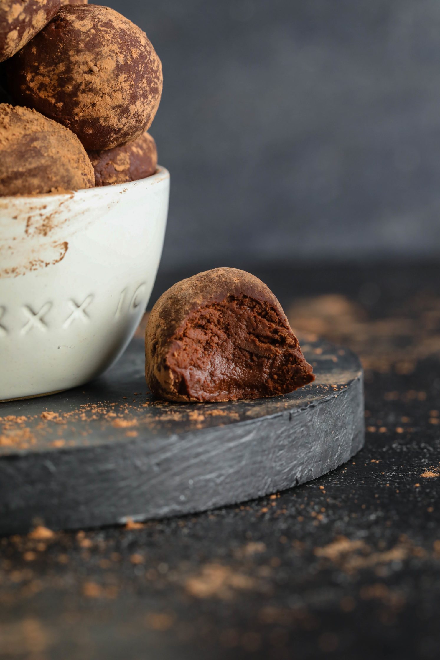 Cacao Dusted Dark Chocolate Truffles with a bite out of it by Flora & Vino 