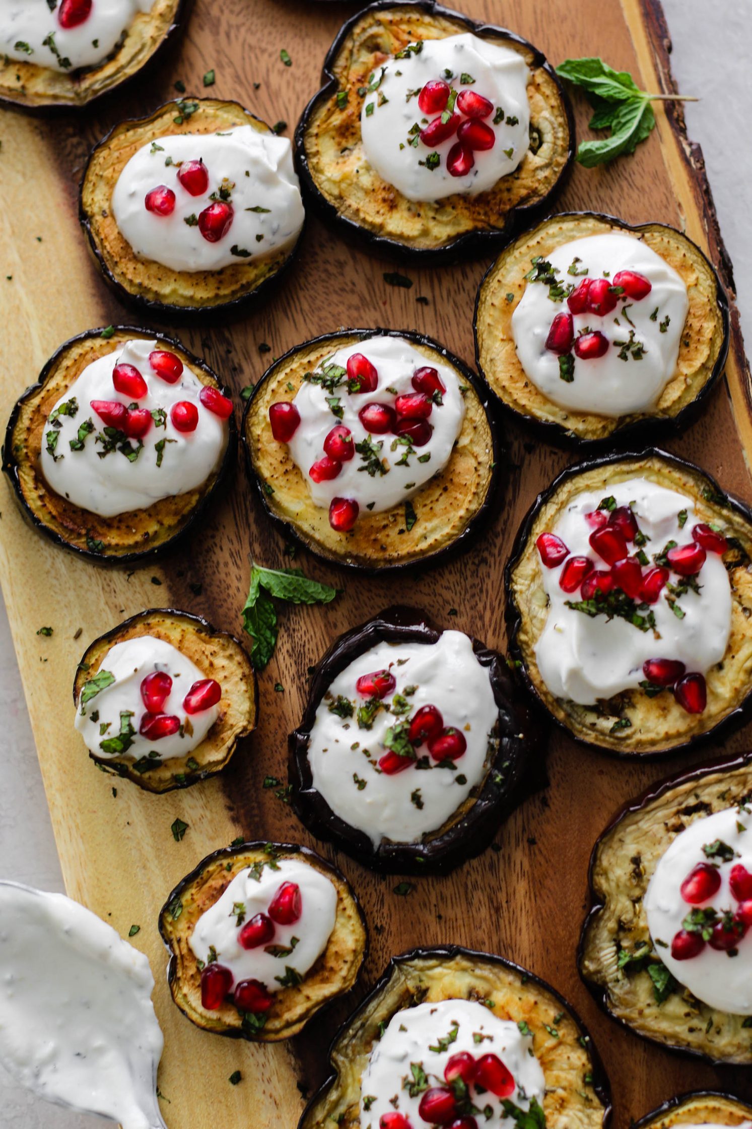 Eggplant Rounds topped with Herbed Yogurt Sauce & Pomegranate by Flora & Vino
