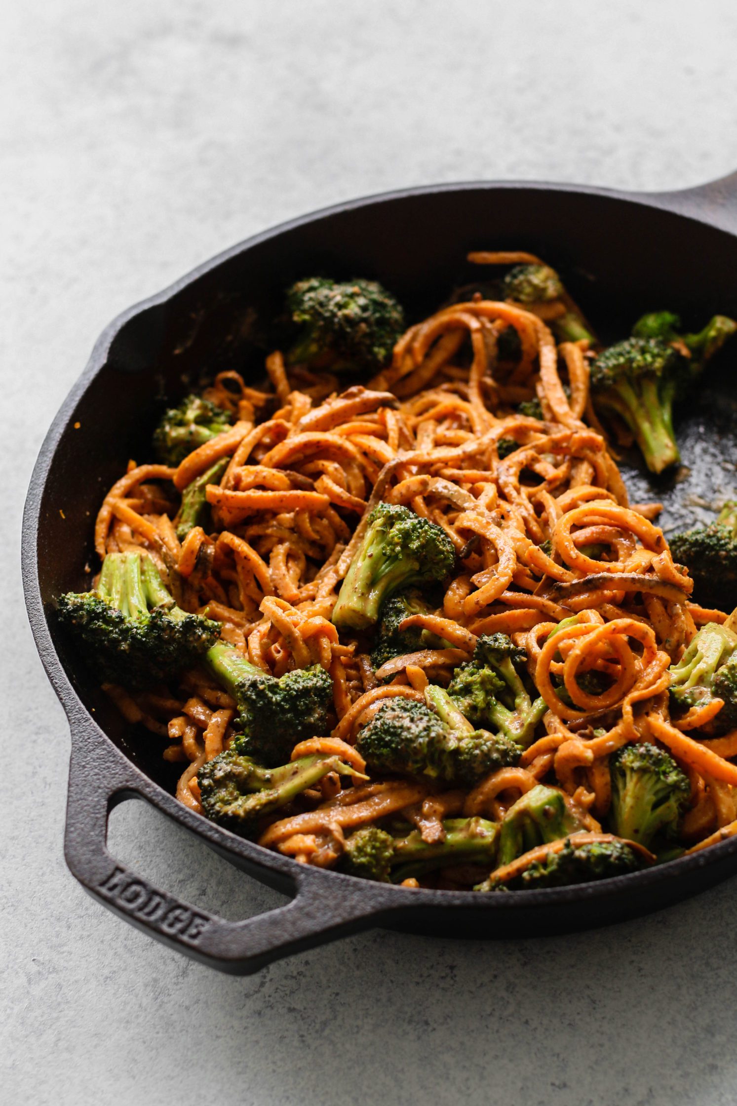 Spicy Almond Butter Sweet Potato Noodles in cast iron skillet by Flora & Vino