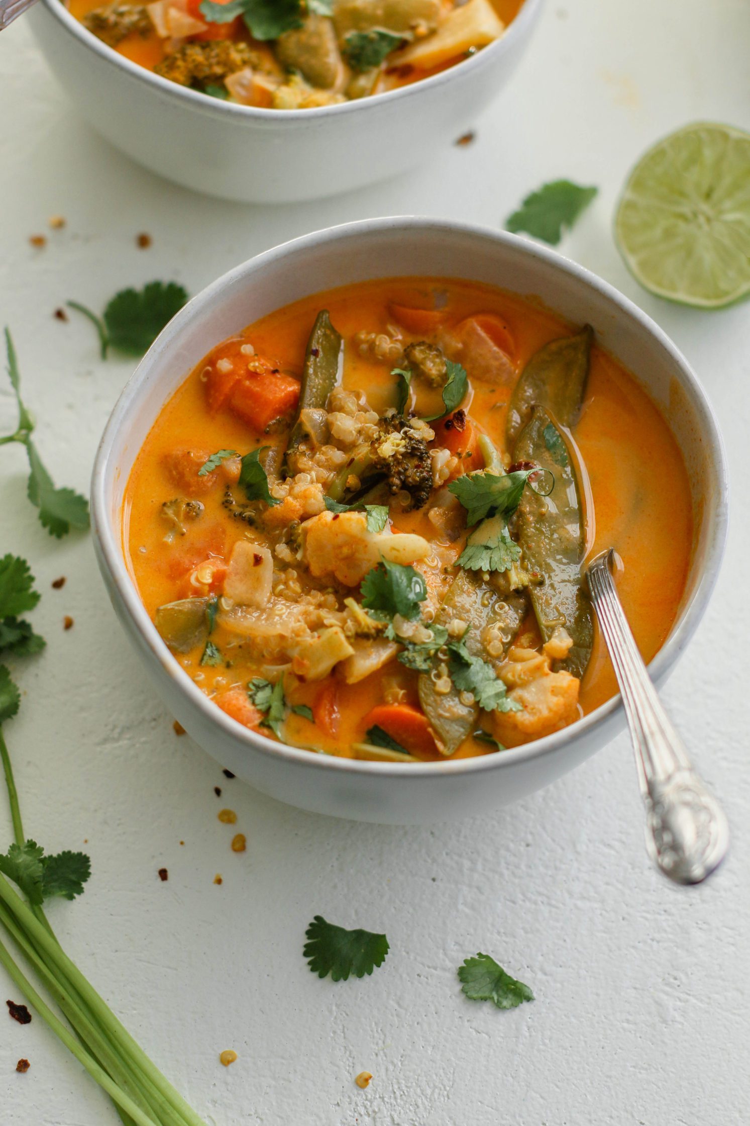 The Quickest Vegan Curry served in bowls with a spoon by Flora & Vino