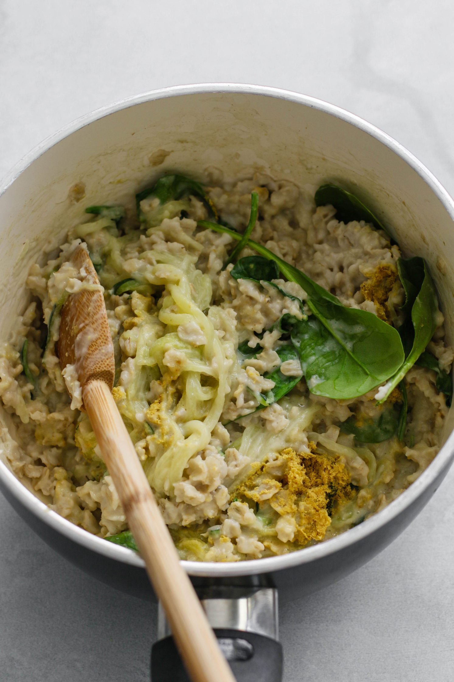 Savory Zucchini Oats in stock pot with wooden spoon